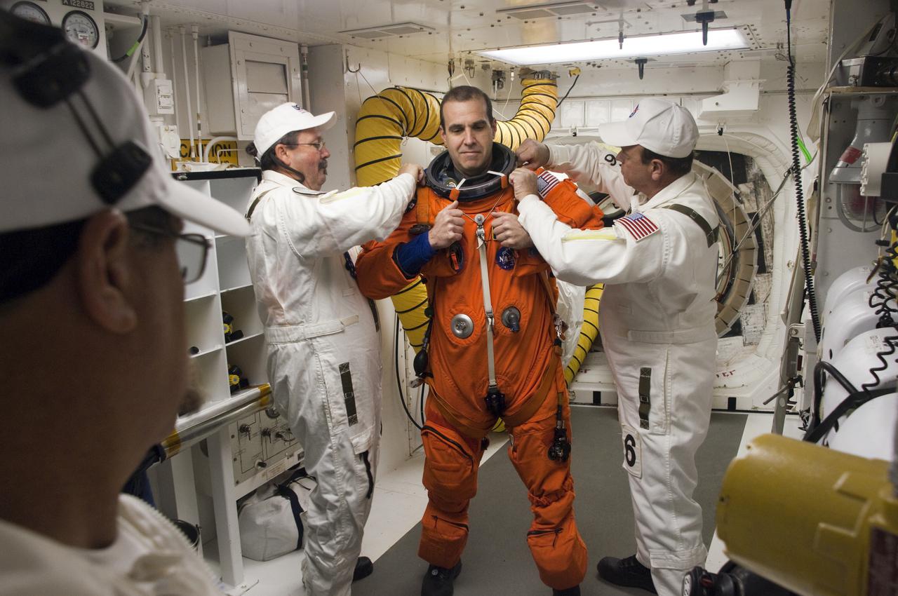 CAPE CANAVERAL, Fla. - At Launch Pad 39A at NASA's Kennedy Space Center in Florida, STS-131 Mission Specialist Rick Mastracchio prepares to enter space shuttle Discovery from the pad's White Room.  The members of space shuttle Discovery's STS-131 crew, dressed in their launch-and-entry suits, are participating in the Terminal Countdown Demonstration Test, or TCDT, a dress rehearsal for launch.  TCDT includes training on the emergency exit systems at the launch pad, driving practice of the M-113 armored personnel carrier and a simulated launch countdown. The crew will deliver the multi-purpose logistics module Leonard, filled with resupply stowage platforms and science racks, to the International Space Station. STS-131, targeted for launch on April 5, will be the 33rd shuttle mission to the station and the 131st shuttle mission overall. For information on the STS-131 mission and crew, visit http:__www.nasa.gov_mission_pages_shuttle_shuttlemissions_sts131_index.htm. Photo credit: NASA_Regina Mitchell-Ryall