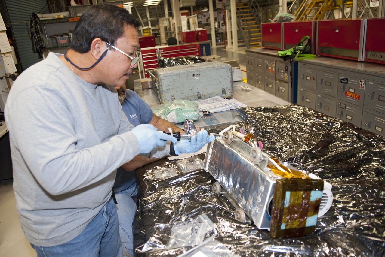 CAPE CANAVERAL, Fla. - In Orbiter Processing Facility-1 at NASA's Kennedy Space Center in Florida, United Space Alliance mid-body mechanic Saul Ngy performs torque checks on a wrist camera before it is installed on the orbiter boom sensor system, or OBSS, in space shuttle Atlantis' payload bay.  Atlantis is being prepared for its upcoming STS-132 mission. The 50-foot-long OBSS attaches to the end of the shuttle’s robotic arm and supports the cameras and laser systems used to inspect the shuttle’s thermal protection system while in space.  Atlantis will deliver an Integrated Cargo Carrier and Russian-built Mini Research Module to the International Space Station on STS-132. Launch is targeted for May 14.  Photo credit: NASA_Jim Grossmann