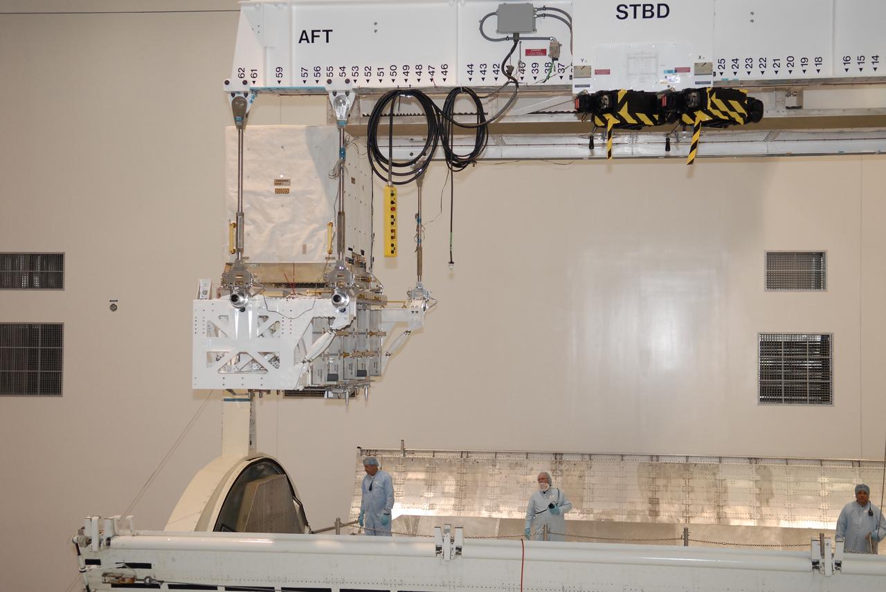 STS-131 LMC Support Structure Carrier Lift & Installation in Canister