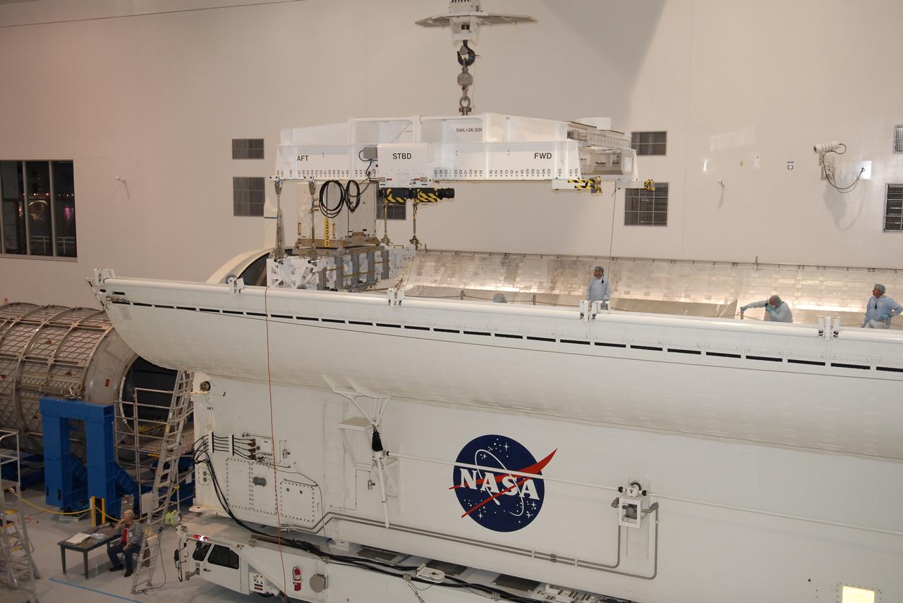 STS-131 LMC Support Structure Carrier Lift & Installation in Canister