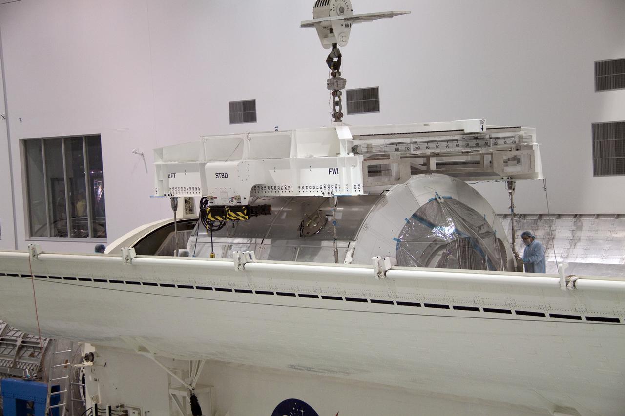 CAPE CANAVERAL, Fla. - In the Space Station Processing Facility at NASA's Kennedy Space Center in Florida, the multi-purpose logistics module Leonardo is lowered into a payload canister.  Leonardo will be transported to Launch Pad 39A and installed into space shuttle Discovery for its upcoming flight.  The seven-member STS-131 crew will deliver Leonardo, filled with resupply stowage platforms and racks, to the International Space Station.  STS-131 will be the 33rd shuttle mission to the station and the 131st shuttle mission overall. Launch is targeted for April 5.  For information on the STS-131 mission and crew, visit http:__www.nasa.gov_mission_pages_shuttle_shuttlemissions_sts131_index.html.  Photo credit: NASA_Jack Pfaller