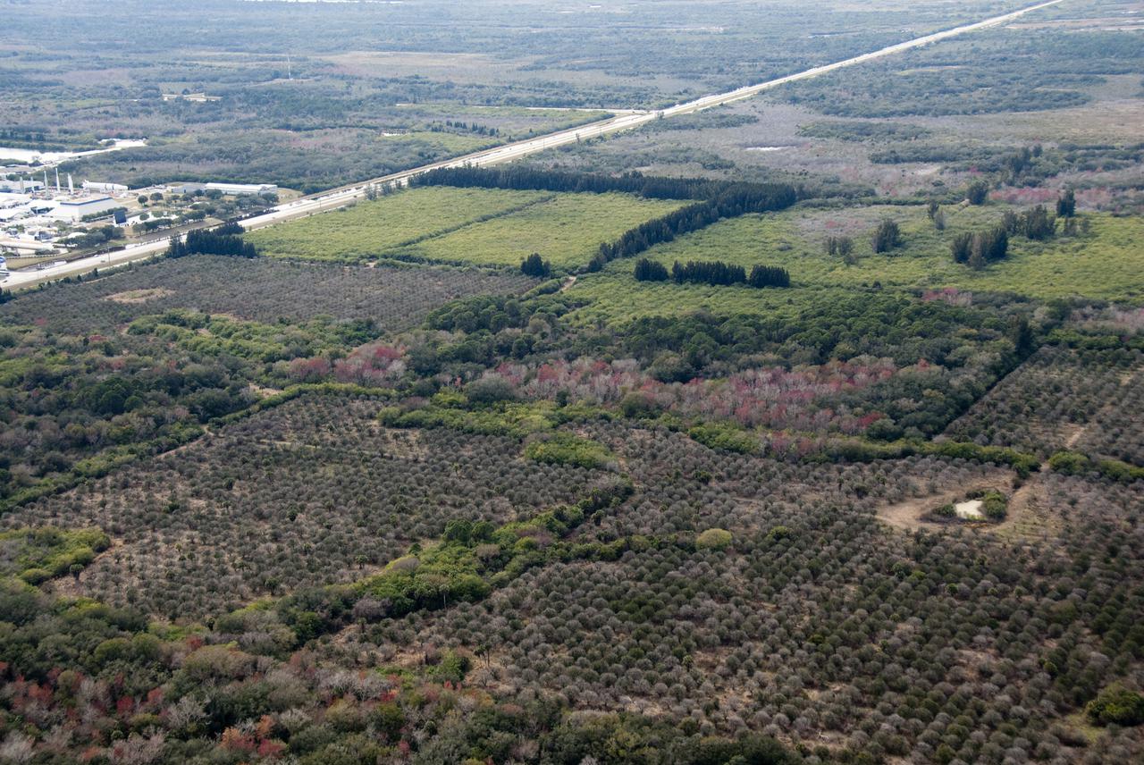 CAPE CANAVERAL, Fla. - This aerial view combines NASA's Kennedy Space Center Visitor Complex (left) and the proposed 500-acre site for one of the largest solar power plants of its kind.   The planned 100-megawatt photovoltaic solar plant would use similar panels to those already built at Kennedy by the SunPower Corp. The energy produced by the proposed facility would be used to provide power to Florida Power and Light customers. Kennedy Center Director Bob Cabana, FPL Vice President and Chief Development Officer Eric Silagy and a SunPower Corp. representative made a joint announcement regarding the new construction during a ceremony held in November 2009 to commission a 1-megawatt solar plant. Included in the announcement were plans to establish a permanent renewable energy research and development center at Exploration Park, Kennedy's new business complex. The dedicated RandD facility proposed for Exploration Park could result in at least 50 high-salary science and engineering positions permanently established at Kennedy by SunPower and FPL's other partners, a potential for solar panel manufacturing located nearby and as many as 1,000 new construction jobs. FPL and Kennedy have initiated environmental studies and a plan to support the next project, which could be initiated before the end of 2010. Photo credit: NASA_Kim Shiflett