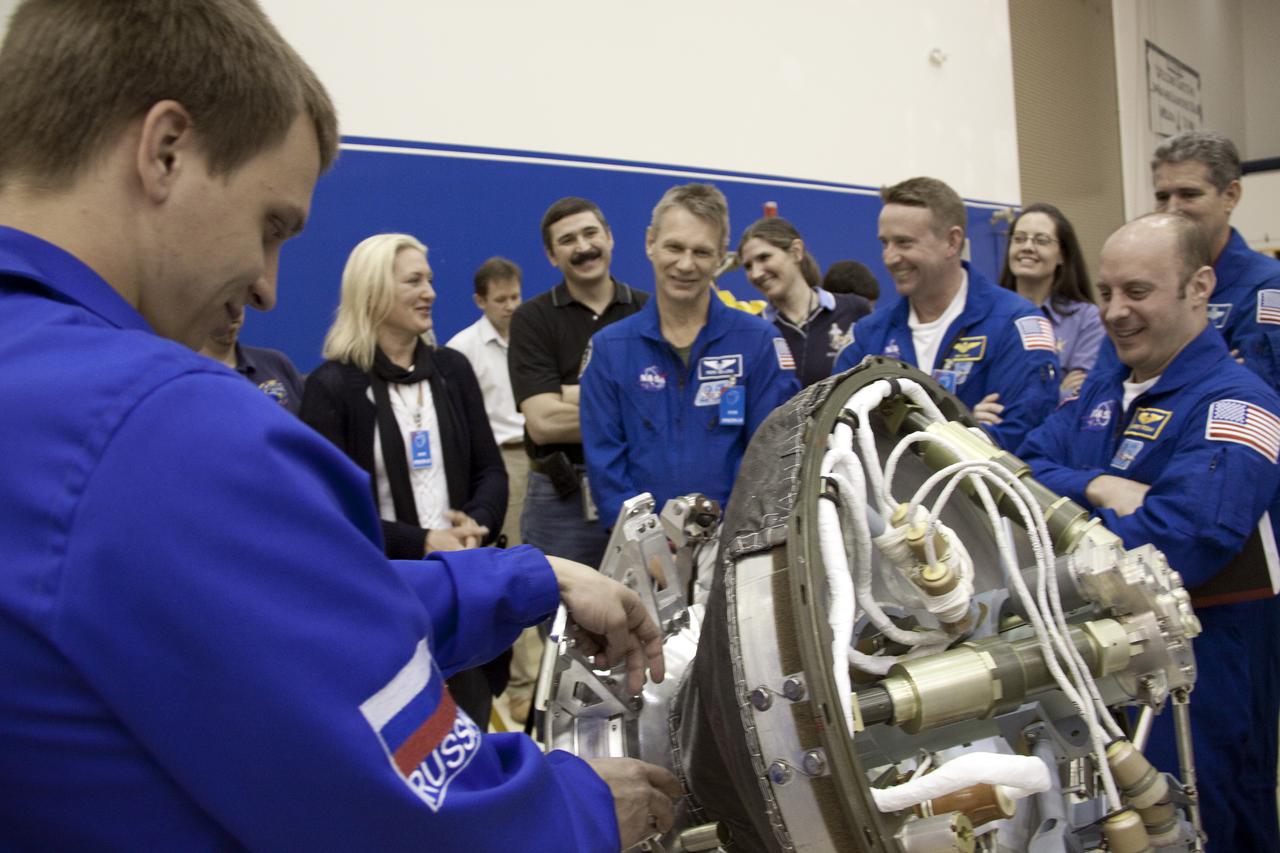 CAPE CANAVERAL, Fla. – At the Astrotech payload processing facility at Port Canaveral in Florida, members of the STS-132 crew receive instruction on the design and operation of the docking mechanism for the Mini-Research Module during their crew equipment interface test, or CEIT. At left is the instructor. From center in the blue flight suits are Mission Specialist Piers Sellers, Commander Ken Ham, and Mission Specialist Garrett Reisman. Mission Specialist Michael Good looks on behind them. CEIT provides the crew with hands-on training and observation of shuttle and flight hardware. The six-member crew of space shuttle Atlantis' STS-132 mission will deliver an Integrated Cargo Carrier and a Russian-built Mini-Research Module to the International Space Station. The second in a series of new pressurized components for Russia, the module will be permanently attached to the bottom port of the Zarya module and also will carry U.S. pressurized cargo. STS-132 is the 34th mission to the station and the 132nd space shuttle mission in the program. Launch is targeted for May 14. For information on the STS-132 mission, visit http:__www.nasa.gov_mission_pages_shuttle_shuttlemissions_sts132_index.html. Photo credit: NASA_Troy Cryder