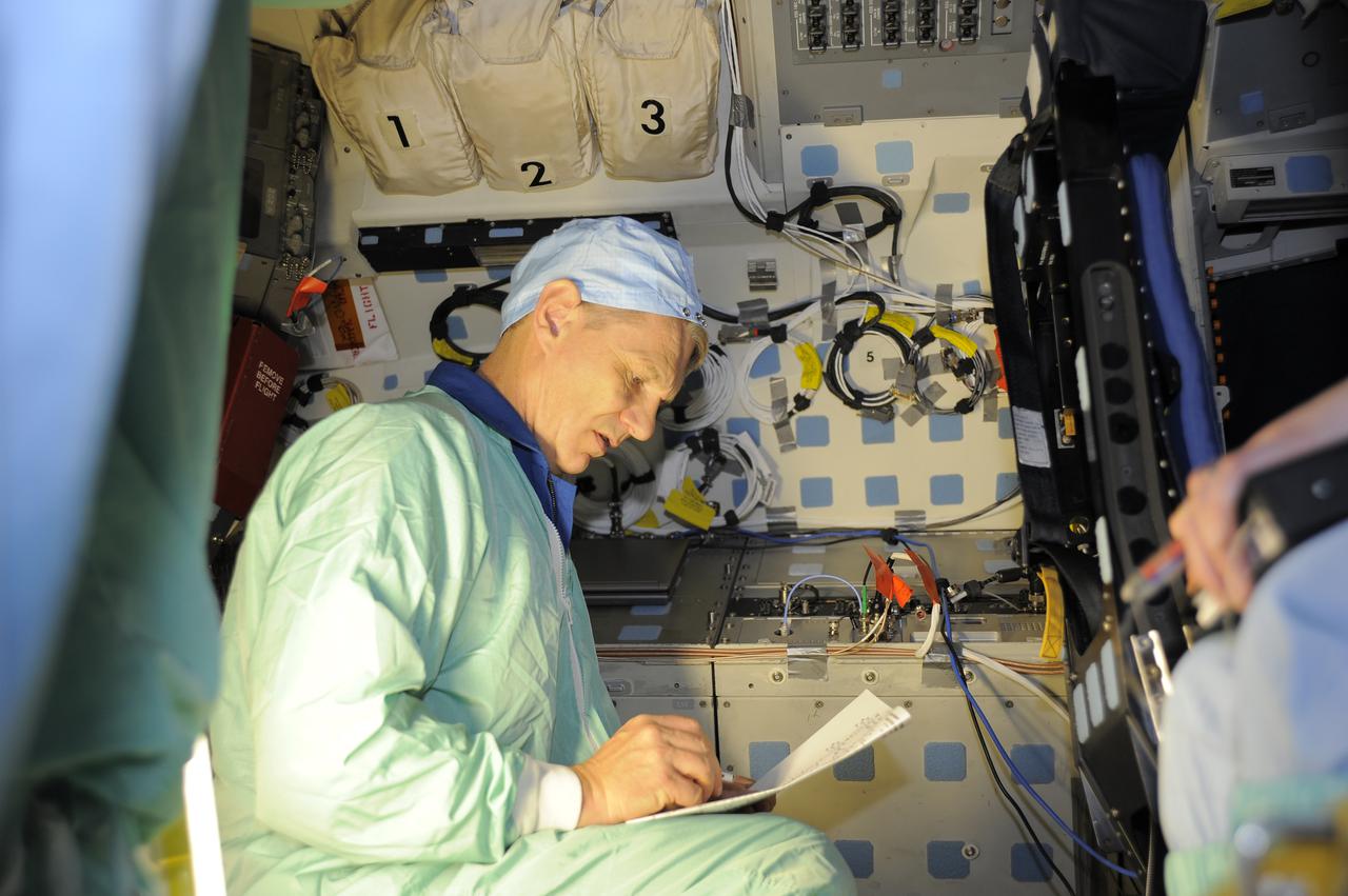 CAPE CANAVERAL, Fla. – In Orbiter Processing Facility-1 at NASA's Kennedy Space Center in Florida, members of space shuttle Atlantis' STS-132 crew participate in training activities during the Crew Equipment Interface Test, or CEIT, for their mission. Here, Mission Specialist Piers Sellers reviews instructions on the operation of the hardware that will fly on Atlantis' middeck. Sellers is dressed in clean room attire, known as a bunny suit. CEIT provides the crew with hands-on training and observation of shuttle and flight hardware. The six-member crew of Atlantis' STS-132 mission will deliver an Integrated Cargo Carrier and the Russian-built Mini-Research Module-1 to the International Space Station. STS-132 is the 34th mission to the station and the 132nd space shuttle mission. Launch is targeted for May 14. For information on the STS-132 mission, visit http:__www.nasa.gov_mission_pages_shuttle_shuttlemissions_sts132_index.html. Photo credit: NASA_Kim Shiflett
