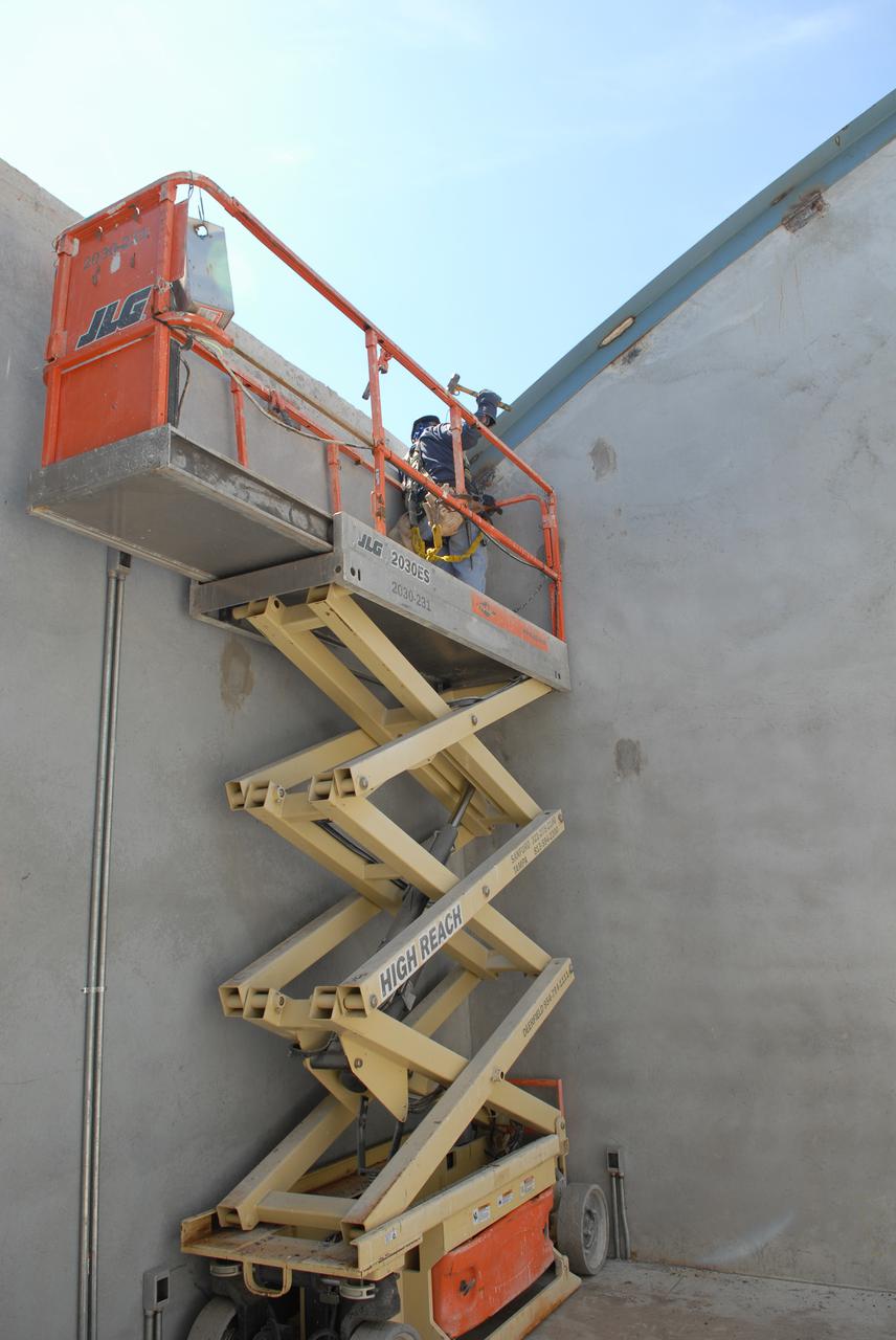 CAPE CANAVERAL, Fla. - In Launch Complex 39 at NASA's Kennedy Space Center in Florida, a worker installs the metal framing that will support the roof beams for the shop building of the Propellants North Administrative and Maintenance Facility.  The facility will have a two-story administrative building to house managers, mechanics and technicians who fuel spacecraft at Kennedy adjacent to an 1,800-square-foot single-story shop to store cryogenic fuel transfer equipment.  The new facility will feature high-efficiency roofs and walls, “Cool Dry Quiet” air conditioning with energy recovery technology, efficient lighting, and other sustainable features. The facility is striving to qualify for the U.S. Green Building Council’s Leadership in Energy and Environmental Design, or LEED, Platinum certification. If successful, Propellants North will be the first Kennedy facility to achieve this highest of LEED ratings after it is completed in December 2010.  The facility was designed for NASA by Jones Edmunds and Associates.  H. W. Davis Construction is the construction contractor. Photo credit: NASA_Jim Grossmann