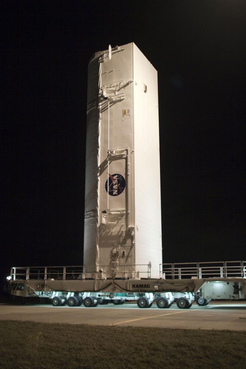 CAPE CANAVERAL, Fla. - At NASA's Kennedy Space Center in Florida, the payload canister containing the multi-purpose logistics module Leonardo stands vertically on a transporter outside the Canister Rotation Facility awaiting its move to Launch Pad 39A. The canister will be transferred into the pad's payload changeout room, and its contents, including Leonardo, is set to be transferred into space shuttle Discovery's cargo bay on March 24. The seven-member STS-131 crew will deliver Leonardo, filled with resupply stowage platforms and racks, to the International Space Station. STS-131 will be the 33rd shuttle mission to the station and the 131st shuttle mission overall. Launch is targeted for April 5. For information on the STS-131 mission and crew, visit http:__www.nasa.gov_mission_pages_shuttle_shuttlemissions_sts131_index.html. Photo credit: NASA_Troy Cryder