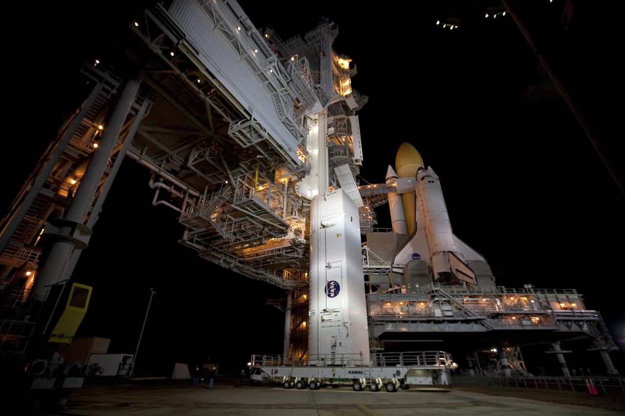 CAPE CANAVERAL, Fla. - At NASA's Kennedy Space Center in Florida, the payload canister containing the multi-purpose logistics module Leonardo, standing vertically on a transporter, arrives at Launch Pad 39A.  The canister next will be lifted into the pad's payload changout room.    Located on the pad's rotating service structure, the room is an enclosed, environmentally controlled area that supports payload delivery and servicing at the pad and attaches to the shuttle's cargo bay for vertical payload installation.  The contents of the canister, including Leonardo, is set to be transferred into space shuttle Discovery's cargo bay on March 24.  The seven-member STS-131 crew will deliver Leonardo, filled with resupply stowage platforms and racks, to the International Space Station.  STS-131 will be the 33rd shuttle mission to the station and the 131st shuttle mission overall. Launch is targeted for April 5.  For information on the STS-131 mission and crew, visit http:__www.nasa.gov_mission_pages_shuttle_shuttlemissions_sts131_index.html.  Photo credit: NASA_Amanda Diller