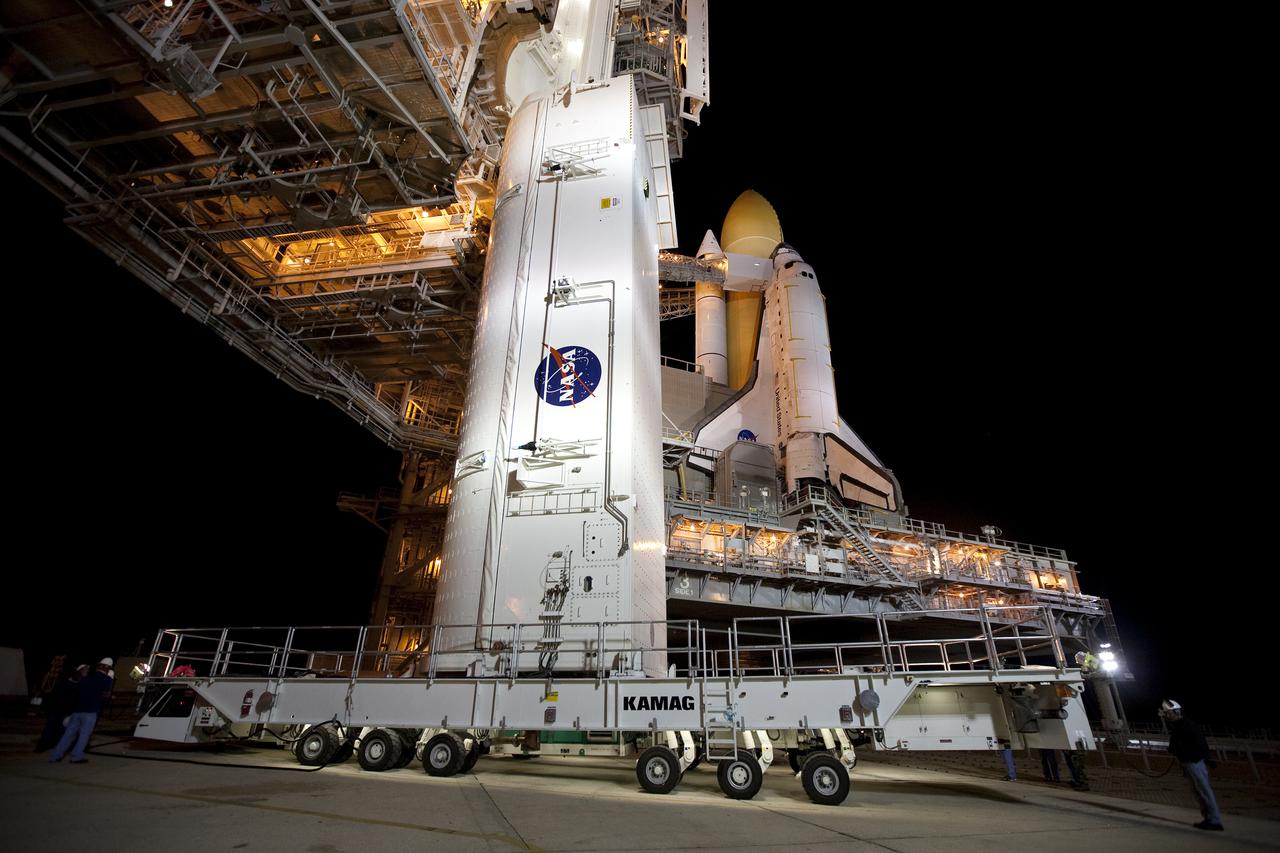 CAPE CANAVERAL, Fla. - At Launch Pad 39A at NASA's Kennedy Space Center in Florida, preparations are under way to lift the payload canister containing the multi-purpose logistics module Leonardo, standing vertically on a transporter, into the pad's payload changout room.    Located on the pad's rotating service structure, the room is an enclosed, environmentally controlled area that supports payload delivery and servicing at the pad and attaches to the shuttle's cargo bay for vertical payload installation.  The contents of the canister, including Leonardo, is set to be transferred into space shuttle Discovery's cargo bay on March 24.  The seven-member STS-131 crew will deliver Leonardo, filled with resupply stowage platforms and racks, to the International Space Station.  STS-131 will be the 33rd shuttle mission to the station and the 131st shuttle mission overall. Launch is targeted for April 5.  For information on the STS-131 mission and crew, visit http:__www.nasa.gov_mission_pages_shuttle_shuttlemissions_sts131_index.html.  Photo credit: NASA_Amanda Diller