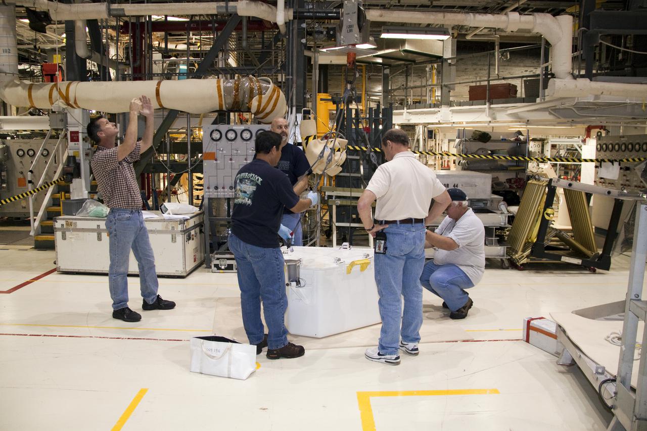 CAPE CANAVERAL, Fla. – In Orbiter Processing Facility-1 at NASA's Kennedy Space Center in Florida, workers prepare to attach the tool stowage assembly to a jib crane that will lift it into space shuttle Atlantis' payload bay. The assembly contains tools and hardware that will be needed on the extravehicular activities, or spacewalks, conducted during the STS-132 mission. On STS-132, the six-member crew will deliver an Integrated Cargo Carrier and a Russian-built Mini-Research Module to the International Space Station. STS-132 is the 34th mission to the station and the 132nd space shuttle mission. Launch is targeted for May 14. For information on the STS-132 mission, visit http:__www.nasa.gov_mission_pages_shuttle_shuttlemissions_sts132_index.html. Photo credit: NASA_Jack Pfaller