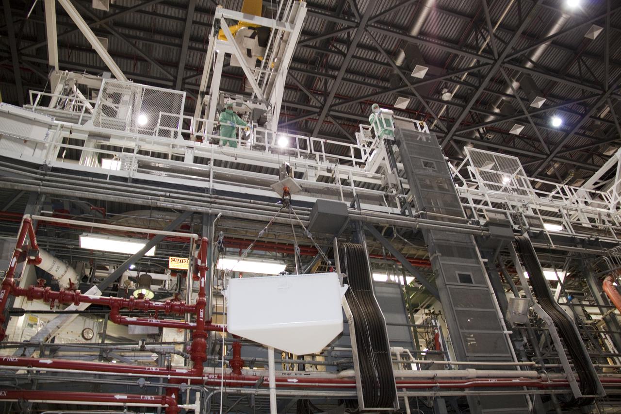 CAPE CANAVERAL, Fla. – In Orbiter Processing Facility-1 at NASA's Kennedy Space Center in Florida, the tool stowage assembly is lifted by jib crane toward the ceiling of the clean room.  The tool box is being installed into space shuttle Atlantis' payload bay.  The assembly contains tools and hardware that will be needed on the extravehicular activities, or spacewalks, conducted during the STS-132 mission. On STS-132, the six-member crew will deliver an Integrated Cargo Carrier and a Russian-built Mini-Research Module to the International Space Station.  STS-132 is the 34th mission to the station and the 132nd space shuttle mission.   Launch is targeted for May 14.  For information on the STS-132 mission, visit http:__www.nasa.gov_mission_pages_shuttle_shuttlemissions_sts132_index.html. Photo credit: NASA_Jack Pfaller