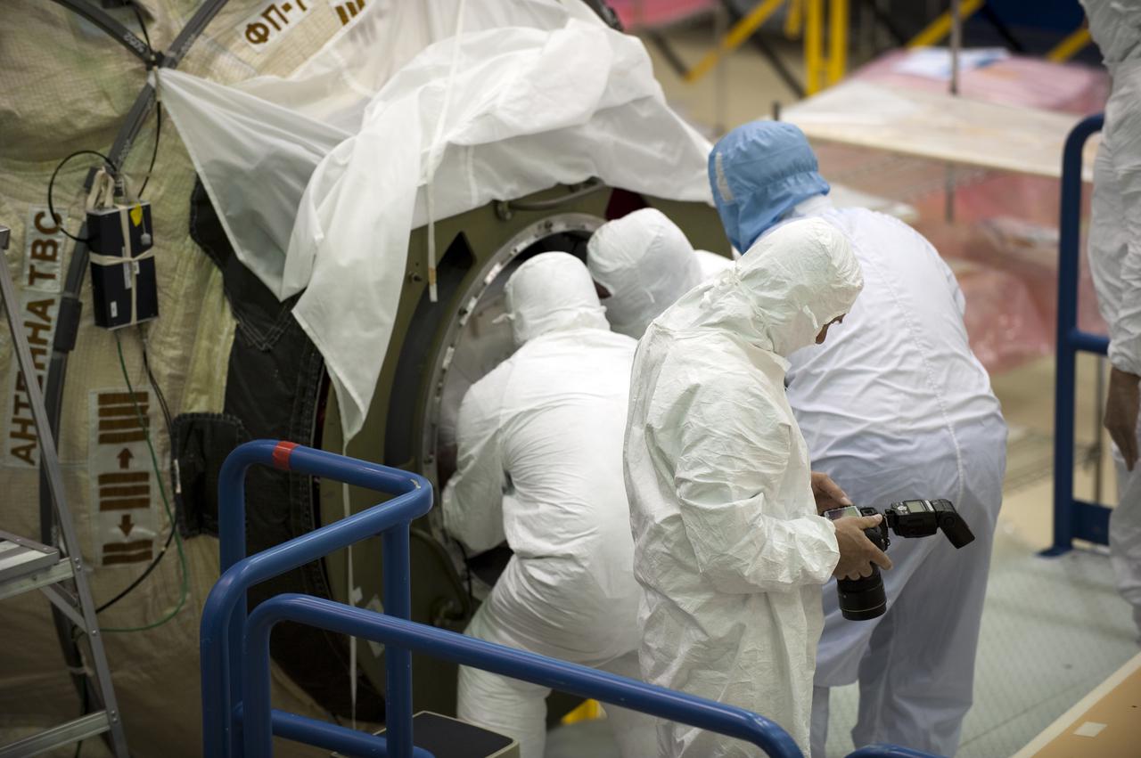 CAPE CANAVERAL, Fla. – In the Astrotech payload processing facility at Port Canaveral, Fla., workers dressed in clean room attire, known as bunny suits, install supplies and other cargo in the Russian-built Mini-Research Module, or MRM, through a hatch on the end of the module. The six-member crew of space shuttle Atlantis' STS-132 mission will deliver an Integrated Cargo Carrier and the MRM to the International Space Station. The second in a series of new pressurized components for Russia, the MRM will be permanently attached to the bottom port of the Zarya module. The MRM also will carry U.S. pressurized cargo. STS-132 is the 34th mission to the station and the 132nd space shuttle mission. Launch is targeted for May 14. For information on the STS-132 mission, visit http:__www.nasa.gov_mission_pages_shuttle_shuttlemissions_sts132_index.html. Photo credit: NASA_Kim Shiflett