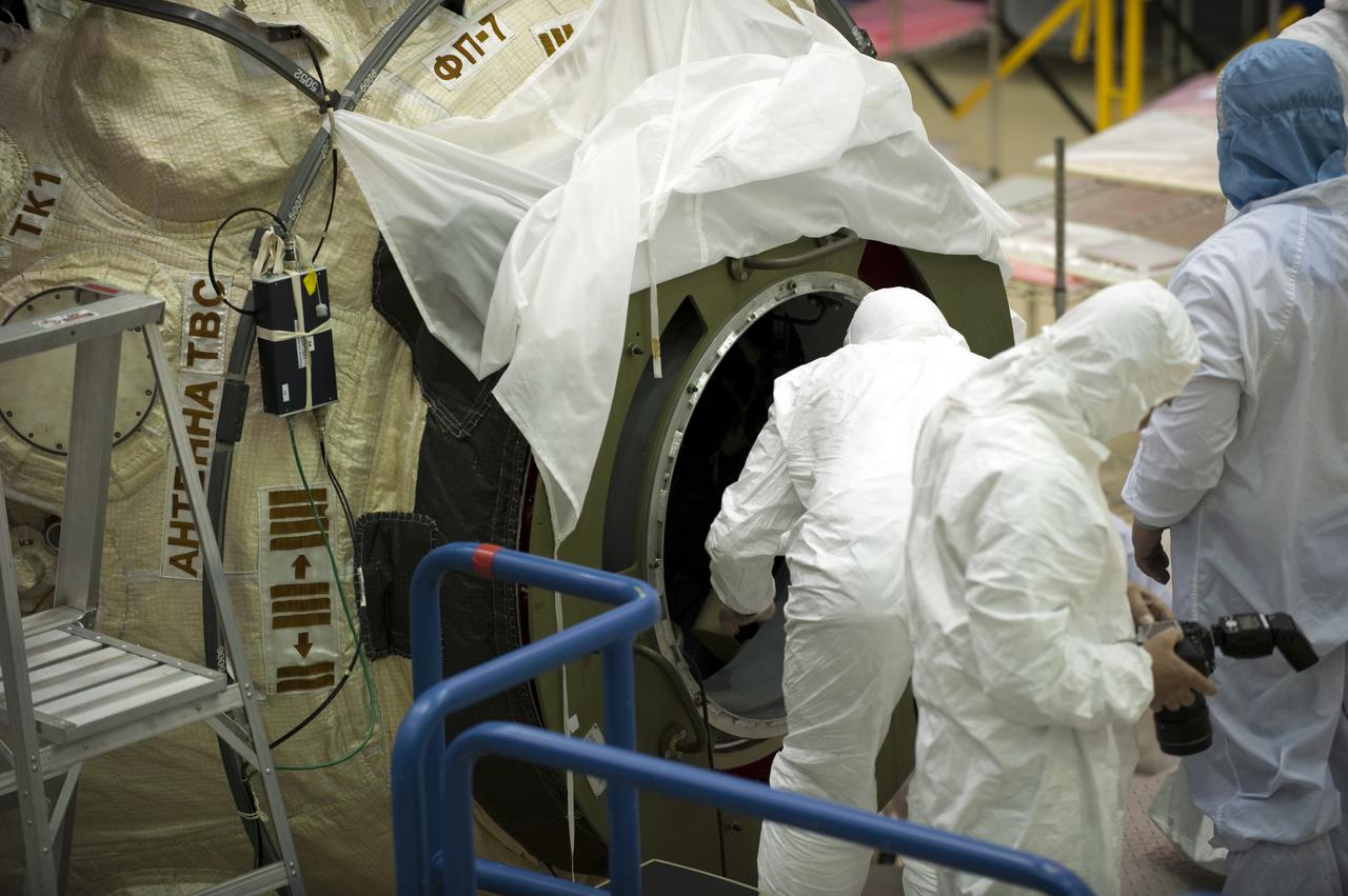 CAPE CANAVERAL, Fla. – In the Astrotech payload processing facility at Port Canaveral, Fla., workers dressed in clean room attire, known as bunny suits, install supplies and other cargo in the Russian-built Mini-Research Module, or MRM, through a hatch on the end of the module. The six-member crew of space shuttle Atlantis' STS-132 mission will deliver an Integrated Cargo Carrier and the MRM to the International Space Station. The second in a series of new pressurized components for Russia, the MRM will be permanently attached to the bottom port of the Zarya module. The MRM also will carry U.S. pressurized cargo. STS-132 is the 34th mission to the station and the 132nd space shuttle mission. Launch is targeted for May 14. For information on the STS-132 mission, visit http:__www.nasa.gov_mission_pages_shuttle_shuttlemissions_sts132_index.html. Photo credit: NASA_Kim Shiflett