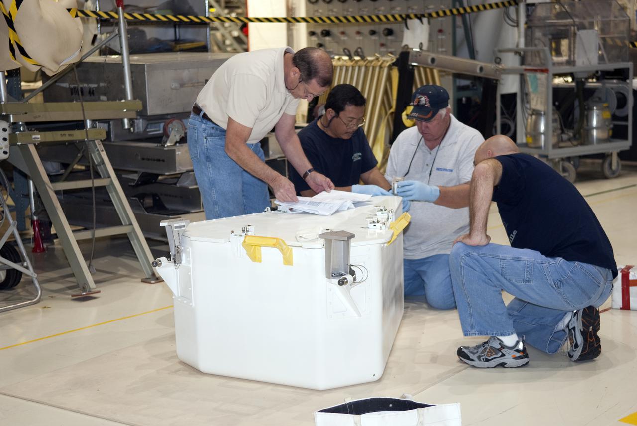 CAPE CANAVERAL, Fla. – In Orbiter Processing Facility-1 at NASA's Kennedy Space Center in Florida, workers prepare the tool stowage assembly for installation into space shuttle Atlantis' payload bay. The assembly contains tools and hardware that will be needed on the extravehicular activities, or spacewalks, conducted during the STS-132 mission. On STS-132, the six-member crew will deliver an Integrated Cargo Carrier and a Russian-built Mini-Research Module to the International Space Station. STS-132 is the 34th mission to the station and the 132nd space shuttle mission. Launch is targeted for May 14. For information on the STS-132 mission, visit http:__www.nasa.gov_mission_pages_shuttle_shuttlemissions_sts132_index.html. Photo credit: NASA_Jim Grossmann