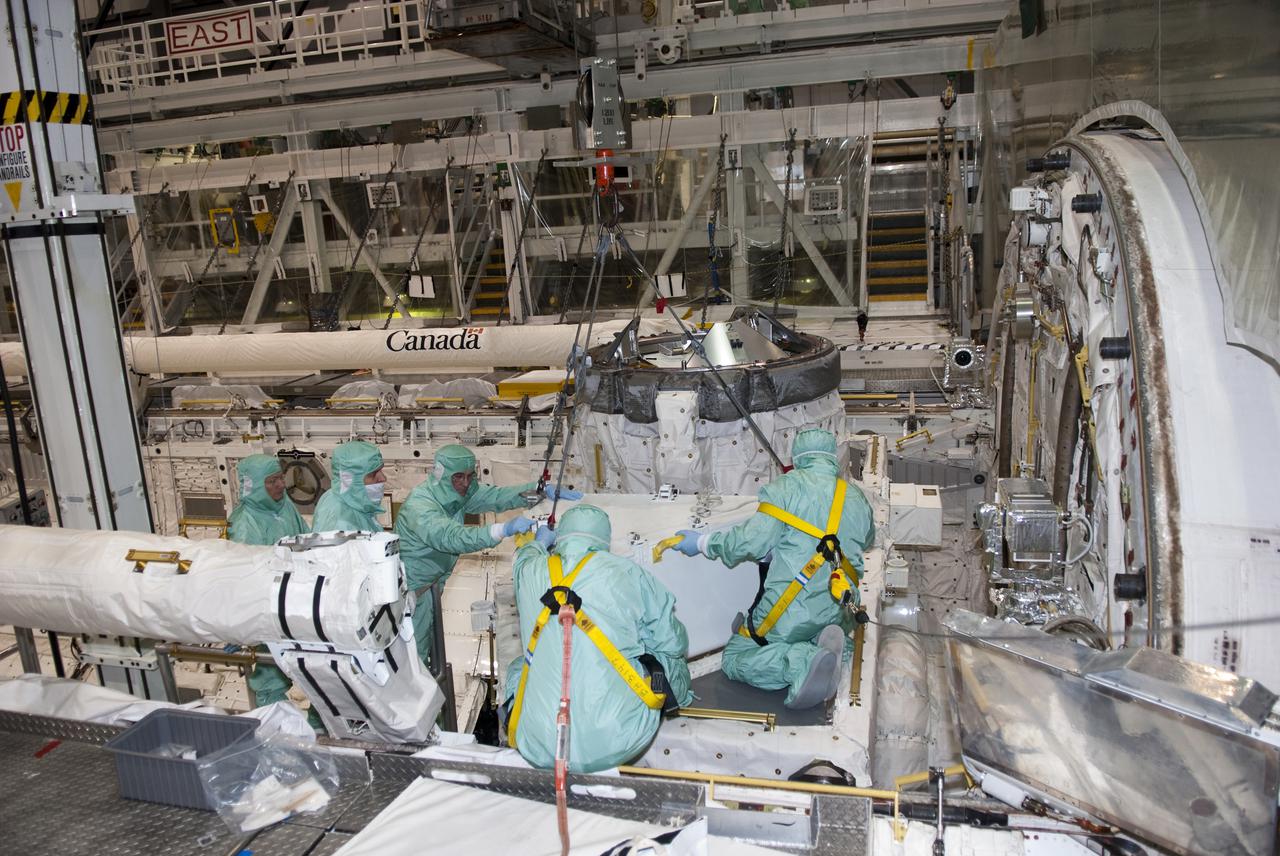 CAPE CANAVERAL, Fla. – In Orbiter Processing Facility-1 at NASA's Kennedy Space Center in Florida, workers dressed in clean room attire, known as bunny suits, guide the tool stowage assembly into position in space shuttle Atlantis' payload bay where it will be installed. The assembly contains tools and hardware that will be needed on the extravehicular activities, or spacewalks, conducted during the STS-132 mission. On STS-132, the six-member crew will deliver an Integrated Cargo Carrier and a Russian-built Mini-Research Module to the International Space Station. STS-132 is the 34th mission to the station and the 132nd space shuttle mission. Launch is targeted for May 14. For information on the STS-132 mission, visit http:__www.nasa.gov_mission_pages_shuttle_shuttlemissions_sts132_index.html. Photo credit: NASA_Jim Grossmann