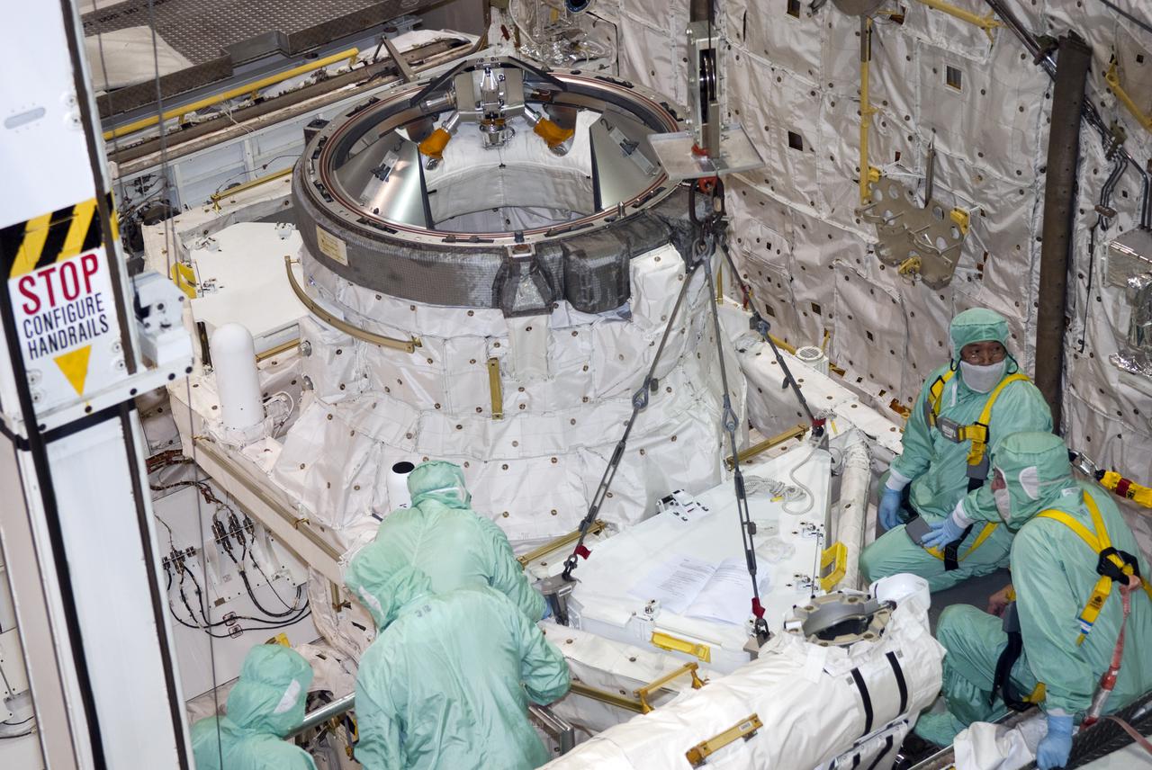 CAPE CANAVERAL, Fla. – In Orbiter Processing Facility-1 at NASA's Kennedy Space Center in Florida, workers dressed in clean room attire, known as bunny suits, ensure the tool stowage assembly is in the proper position in space shuttle Atlantis' payload bay for installation. The assembly contains tools and hardware that will be needed on the extravehicular activities, or spacewalks, conducted during the STS-132 mission. On STS-132, the six-member crew will deliver an Integrated Cargo Carrier and a Russian-built Mini-Research Module to the International Space Station. STS-132 is the 34th mission to the station and the 132nd space shuttle mission. Launch is targeted for May 14. For information on the STS-132 mission, visit http:__www.nasa.gov_mission_pages_shuttle_shuttlemissions_sts132_index.html. Photo credit: NASA_Jim Grossmann