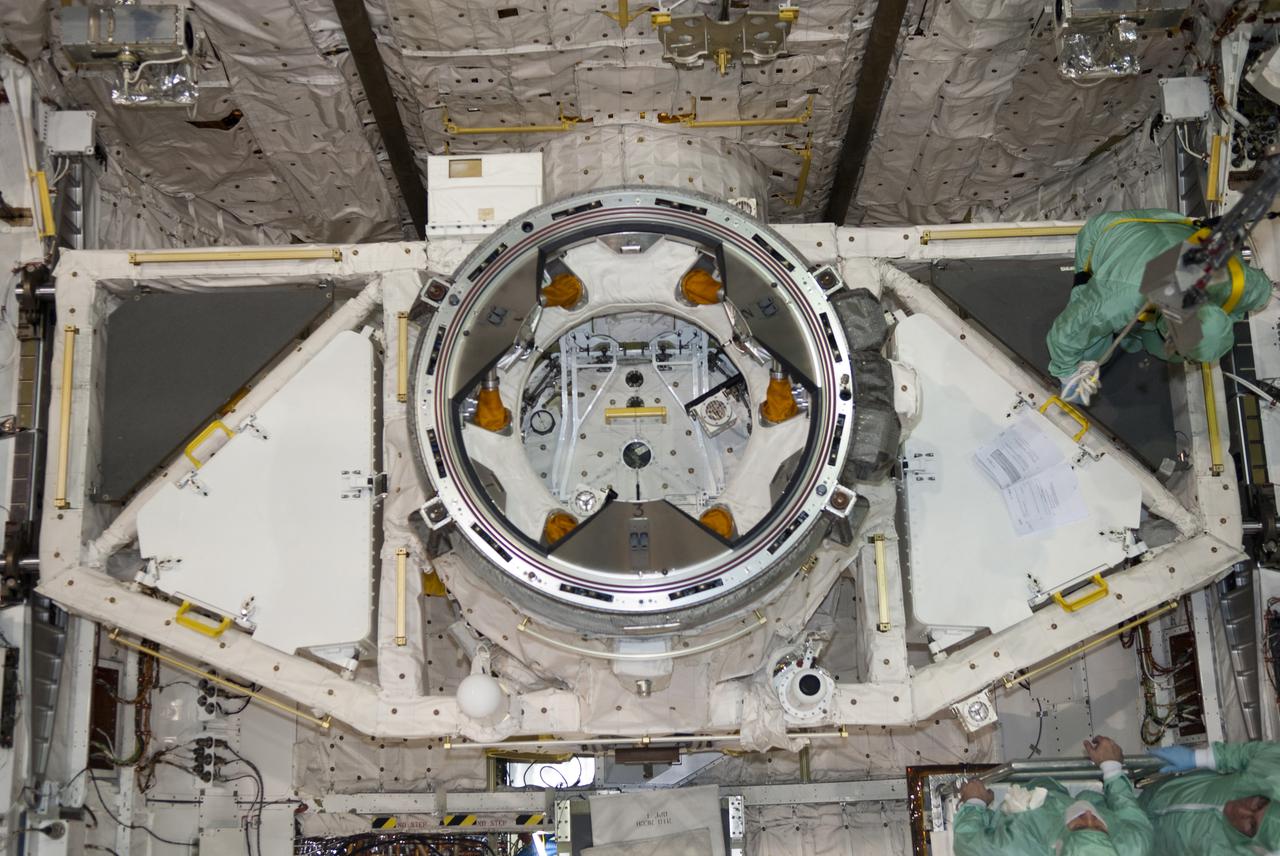 CAPE CANAVERAL, Fla. – In Orbiter Processing Facility-1 at NASA's Kennedy Space Center in Florida, workers dressed in clean room attire, known as bunny suits, disconnect the tool stowage assembly from the jib crane which delivered it into space shuttle Atlantis' payload bay. The assembly contains tools and hardware that will be needed on the extravehicular activities, or spacewalks, conducted during the STS-132 mission. On STS-132, the six-member crew will deliver an Integrated Cargo Carrier and a Russian-built Mini-Research Module to the International Space Station. STS-132 is the 34th mission to the station and the 132nd space shuttle mission. Launch is targeted for May 14. For information on the STS-132 mission, visit http:__www.nasa.gov_mission_pages_shuttle_shuttlemissions_sts132_index.html. Photo credit: NASA_Jim Grossmann