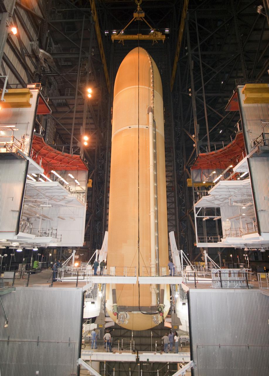 CAPE CANAVERAL, Fla. - In the Vehicle Assembly Building at NASA's Kennedy Space Center in Florida, technicians watch as the external fuel tank for space shuttle Atlantis' STS-132 mission, ET-136, is lowered between the twin solid rocket boosters. The external tank arrived at Kennedy from NASA's Michoud Assembly Facility on March 1 aboard the Pegasus barge. The six-member STS-132 crew will deliver an Integrated Cargo Carrier and a Russian-built Mini-Research Module, or MRM-1, to the International Space Station. Launch is targeted for May 14. For information on the STS-132 mission, visit http:__www.nasa.gov_mission_pages_shuttle_shuttlemissions_sts132_index.html. Photo credit: NASA_Jack Pfaller