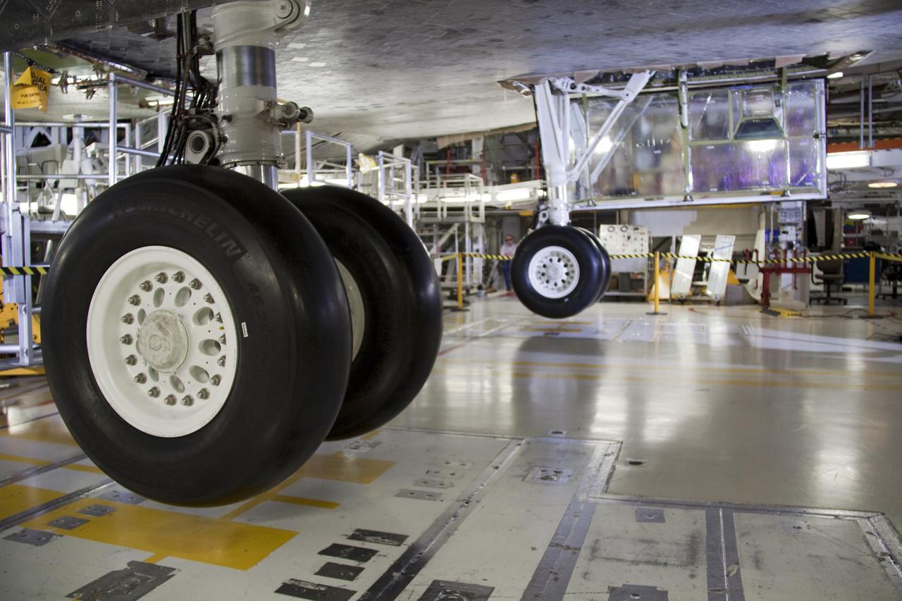 CAPE CANAVERAL, Fla. – In Orbiter Processing Facility-1 at NASA's Kennedy Space Center in Florida, space shuttle Atlantis' rear landing gears are extended and appear to hover over the clean room floor during processing of the shuttle.  Changes to the thermal protection system tiles on the periphery of the landing gear doors necessitate that the gears be extended to ensure the doors open properly without obstruction.  The practice is standard procedure between shuttle flights.   The six-member crew of space shuttle Atlantis' STS-132 mission will deliver an Integrated Cargo Carrier and the Russian-built Mini-Research Module-1, known as Rassvet, to the International Space Station.  The second in a series of new pressurized components for Russia, Rassvet will be permanently attached to the Earth-facing port of the Zarya control module. Rassvet, which translates to 'dawn,' will be used for cargo storage and provide an additional docking port to the station.  STS-132 is the 34th mission to the station and the 132nd shuttle mission overall.   Launch is targeted for May 14.  For information on the STS-132 mission, visit http:__www.nasa.gov_mission_pages_shuttle_shuttlemissions_sts132_index.html. Photo credit: NASA_Gianni Woods