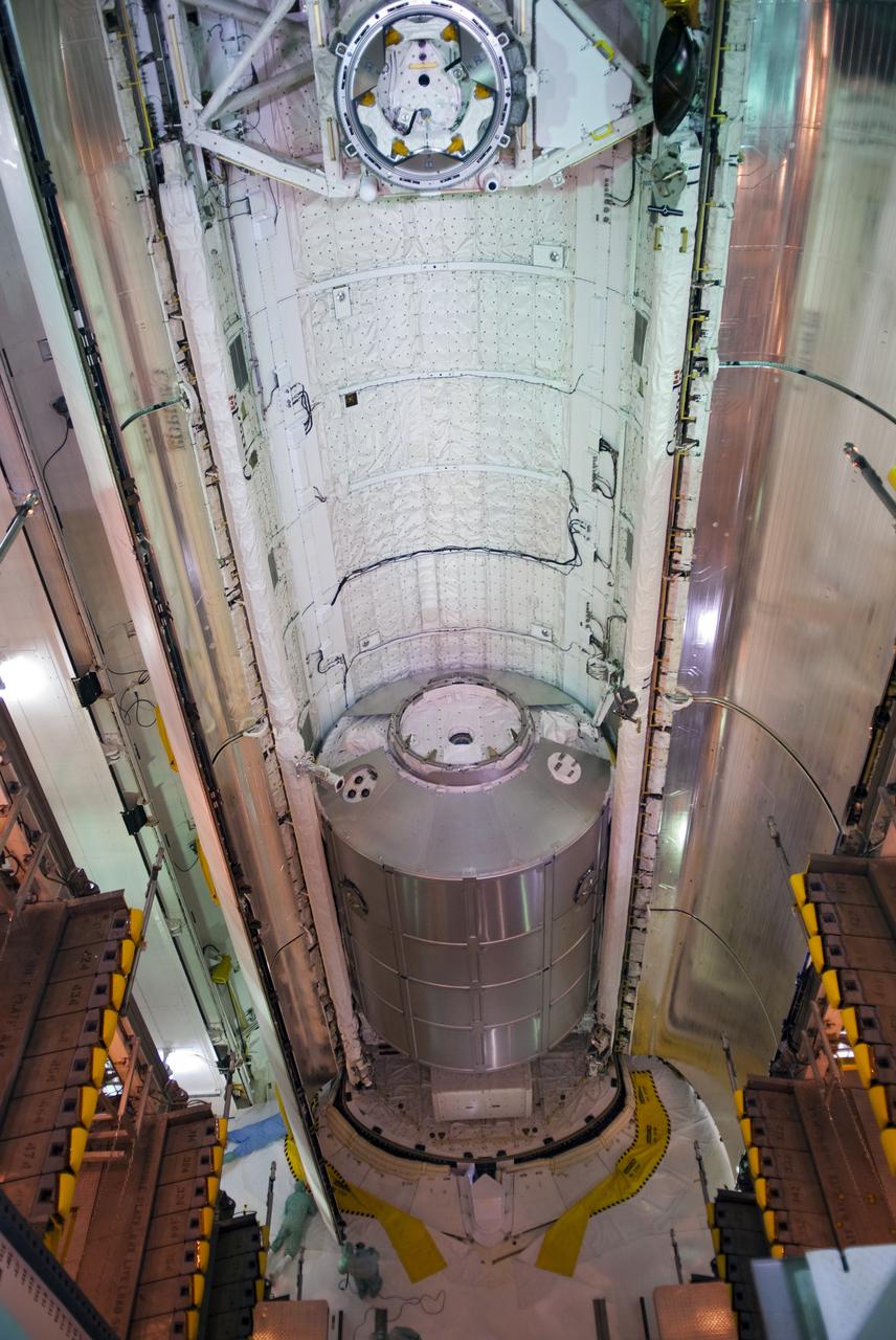 CAPE CANAVERAL, Fla. - At Launch Pad 39A at NASA's Kennedy Space Center in Florida, space shuttle Discovery's payload bay doors begin to close around the multi-purpose logistics module Leonardo and other cargo that will fly on the STS-131 mission.  Payload bay door closure for launch is a significant milestone in processing activities.  The countdown for Discovery's launch on April 5 is set to begin at 3 a.m. EDT on April 2.  The seven-member STS-131 crew will deliver Leonardo to the International Space Station.  The module is filled with supplies, a new crew sleeping quarters and science racks that will be transferred to the station's laboratories.  The crew also will switch out a gyroscope on the station’s truss, install a spare ammonia storage tank and retrieve a Japanese experiment from the station’s exterior.  STS-131 is the 33rd shuttle mission to the station and the 131st shuttle mission overall.  For information on the STS-131 mission and crew, visit http:__www.nasa.gov_mission_pages_shuttle_shuttlemissions_sts131_index.html.  Photo credit: NASA_Jim Grossmann