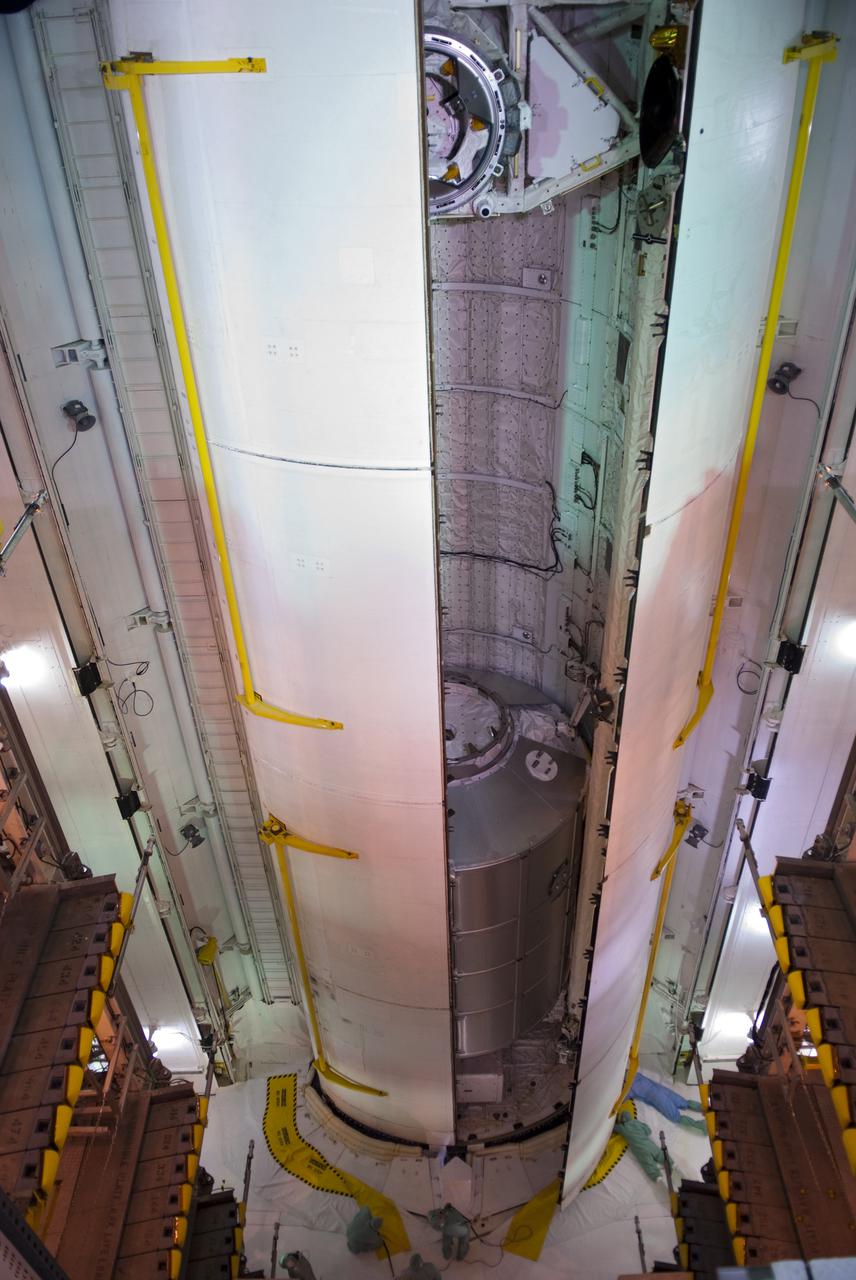 CAPE CANAVERAL, Fla. - At Launch Pad 39A at NASA's Kennedy Space Center in Florida, the second of space shuttle Discovery's payload bay doors close around the orbiter docking system and the multi-purpose logistics module Leonardo and other cargo that will fly on the STS-131 mission.  Payload bay door closure for launch is a significant milestone in processing activities.  The countdown for Discovery's launch on April 5 is set to begin at 3 a.m. EDT on April 2.  The seven-member STS-131 crew will deliver Leonardo to the International Space Station.  The module is filled with supplies, a new crew sleeping quarters and science racks that will be transferred to the station's laboratories.  The crew also will switch out a gyroscope on the station’s truss, install a spare ammonia storage tank and retrieve a Japanese experiment from the station’s exterior.  STS-131 is the 33rd shuttle mission to the station and the 131st shuttle mission overall.  For information on the STS-131 mission and crew, visit http:__www.nasa.gov_mission_pages_shuttle_shuttlemissions_sts131_index.html.  Photo credit: NASA_Jim Grossmann