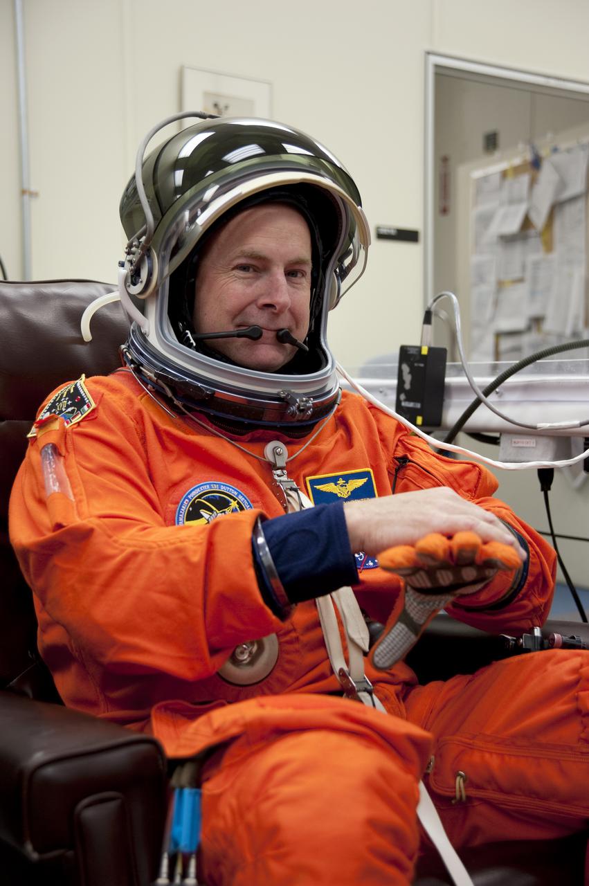 CAPE CANAVERAL, Fla. - In the Operations and Checkout Building at NASA's Kennedy Space Center in Florida, the astronauts of space shuttle Discovery's STS-131 crew put on their launch-and-entry suits before heading to the Astrovan for the ride to Launch Pad 39A. Commander Alan Poindexter, seen here, checks the fit of his gloves.  Liftoff of the STS-131 mission is set for 6:21 a.m. EDT on April 5. On STS-131, the seven-member crew will deliver the multi-purpose logistics module Leonardo, filled with supplies, a new crew sleeping quarters and science racks that will be transferred to the International Space Station's laboratories.  The crew also will switch out a gyroscope on the station’s truss, install a spare ammonia storage tank and retrieve a Japanese experiment from the station’s exterior.  STS-131 is the 33rd shuttle mission to the station and the 131st shuttle mission overall. For information on the STS-131 mission and crew, visit http:__www.nasa.gov_mission_pages_shuttle_shuttlemissions_sts131_index.html.  Photo credit: NASA_Kim Shiflett