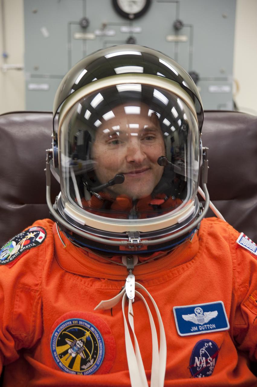 CAPE CANAVERAL, Fla. - In the Operations and Checkout Building at NASA's Kennedy Space Center in Florida, the astronauts of space shuttle Discovery's STS-131 crew put on their launch-and-entry suits before heading to the Astrovan for the ride to Launch Pad 39A. Pilot James P. Dutton Jr., seen here, checks the fit of his suit's helmet.  Liftoff of the STS-131 mission is set for 6:21 a.m. EDT on April 5. On STS-131, the seven-member crew will deliver the multi-purpose logistics module Leonardo, filled with supplies, a new crew sleeping quarters and science racks that will be transferred to the International Space Station's laboratories.  The crew also will switch out a gyroscope on the station’s truss, install a spare ammonia storage tank and retrieve a Japanese experiment from the station’s exterior.  STS-131 is the 33rd shuttle mission to the station and the 131st shuttle mission overall. For information on the STS-131 mission and crew, visit http:__www.nasa.gov_mission_pages_shuttle_shuttlemissions_sts131_index.html.  Photo credit: NASA_Kim Shiflett