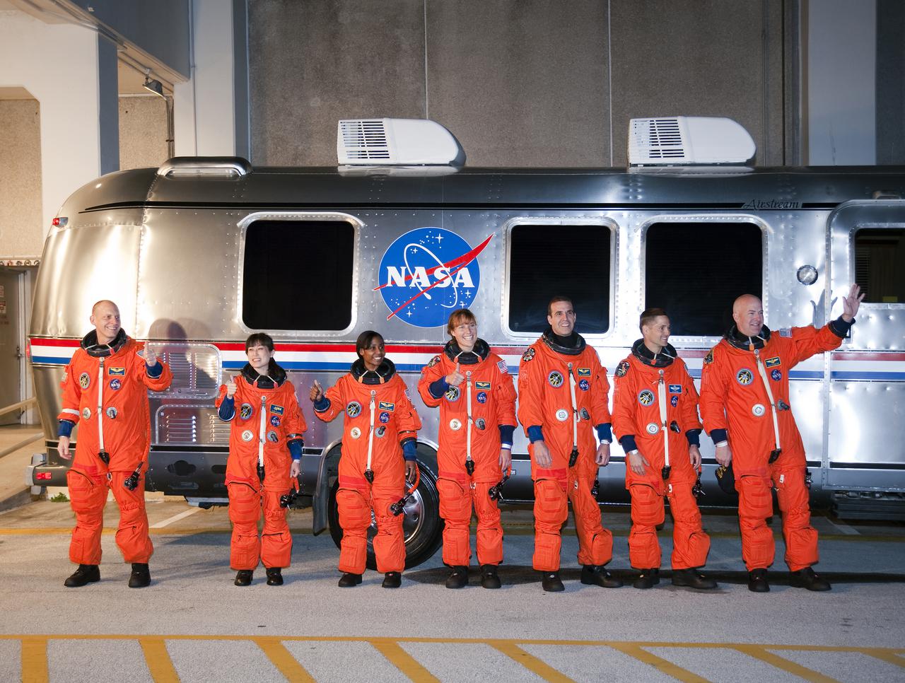 CAPE CANAVERAL, Fla. - At NASA's Kennedy Space Center in Florida, the astronauts on space shuttle Discovery's STS-131 crew, dressed in their orange launch-and-entry suits, pause for a group portrait in front of the Astrovan that will transport them to Launch Pad 39A. From left are Mission Specialists Clayton Anderson, Naoko Yamazaki of the Japan Aerospace Exploration Agency, Stephanie Wilson, Dorothy Metcalf-Lindenburger and Rick Mastracchio; Pilot James P. Dutton Jr.; and Commander Alan Poindexter. Liftoff of the STS-131 mission is set for 6:21 a.m. EDT on April 5. On STS-131, the seven-member crew will deliver the multi-purpose logistics module Leonardo, filled with supplies, a new crew sleeping quarters and science racks that will be transferred to the International Space Station's laboratories. The crew also will switch out a gyroscope on the station’s truss, install a spare ammonia storage tank and retrieve a Japanese experiment from the station’s exterior. STS-131 is the 33rd shuttle mission to the station and the 131st shuttle mission overall. For information on the STS-131 mission and crew, visit http:__www.nasa.gov_mission_pages_shuttle_shuttlemissions_sts131_index.html. Photo credit: NASA_Kim Shiflett