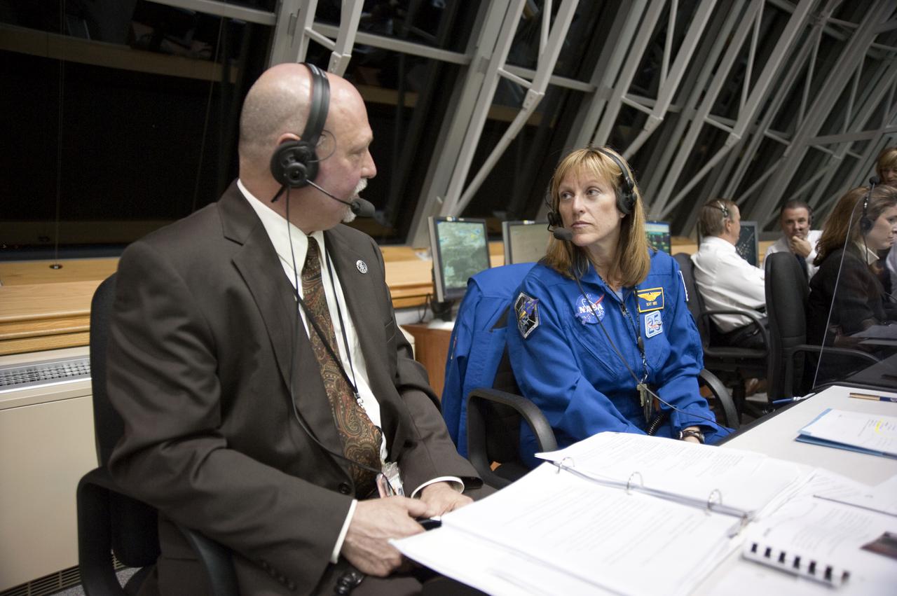 CAPE CANAVERAL, Fla. - NASA Commentator Mike Curie and Astronaut Kathryn 'Kay' Hire discuss the launch of space shuttle Discovery on the STS-131 mission in the Launch Control Center's Firing Room 4 at NASA's Kennedy Space Center in Florida.  The seven-member STS-131 crew will deliver the multi-purpose logistics module Leonardo, filled with supplies, a new crew sleeping quarters and science racks that will be transferred to the International Space Station's laboratories. The crew also will switch out a gyroscope on the station’s truss, install a spare ammonia storage tank and retrieve a Japanese experiment from the station’s exterior. STS-131 is the 33rd shuttle mission to the station and the 131st shuttle mission overall. For information on the STS-131 mission and crew, visit http:__www.nasa.gov_mission_pages_shuttle_shuttlemissions_sts131_index.html. Photo credit: NASA_Kim Shiflett