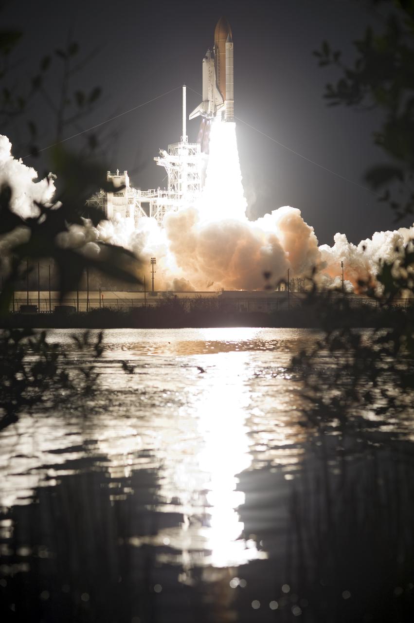 CAPE CANAVERAL, Fla.  - Soaring above Launch Pad 39A's towers, space shuttle Discovery heads skyward on its STS-131 mission leaving NASA's Kennedy Space Center behind racing toward the International Space Station.  Shuttle Discovery lifted off at 6:21 a.m. EDT on April 5, 2010. The seven-member STS-131 crew will deliver the multi-purpose logistics module Leonardo, filled with supplies, a new crew sleeping quarters and science racks that will be transferred to the International Space Station's laboratories. The crew also will switch out a gyroscope on the station’s truss, install a spare ammonia storage tank and retrieve a Japanese experiment from the station’s exterior. STS-131 is the 33rd shuttle mission to the station and the 131st shuttle mission overall. For information on the STS-131 mission and crew, visit http:__www.nasa.gov_mission_pages_shuttle_shuttlemissions_sts131_index.html.  Photo credit: NASA_Tony Gray and Tom Farrar