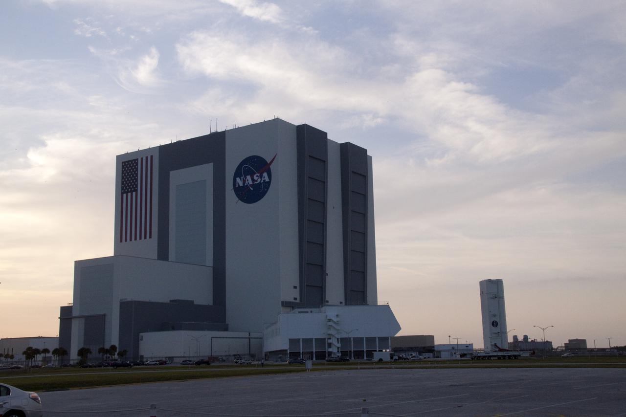 CAPE CANAVERAL, Fla. - At NASA's Kennedy Space Center in Florida, the payload canister containing the primary payloads for the STS-132 mission, standing vertically on a transporter, travels past the Vehicle Assembly Building on its way at Launch Pad 39A.  Once at the pad, the canister will be lifted into the payload changout room. Located on the pad's rotating service structure, the room is an enclosed, environmentally controlled area that supports payload delivery and servicing at the pad and mates to the shuttle's cargo bay for vertical payload installation. The payloads secured inside the canister include an Integrated Cargo Carrier, or ICC, and the Russian-built Mini-Research Module-1, or MRM-1, which will be delivered to the International Space Station aboard space shuttle Atlantis.  The ICC is an unpressurized flat bed pallet and keel yoke assembly used to support the transfer of exterior cargo from the shuttle to the space station.  The MRM-1, known as Rassvet, is the second in a series of new pressurized components for Russia and will be permanently attached to the Earth-facing port of the Zarya control module. Rassvet, which translates to 'dawn,' will be used for cargo storage and will provide an additional docking port to the station.  STS-132 is the 34th mission to the station and the 132nd shuttle mission overall.   Launch is targeted for May 14.  For information on the STS-132 mission, visit http:__www.nasa.gov_mission_pages_shuttle_shuttlemissions_sts132_index.html. Photo credit: NASA_Jack Pfaller