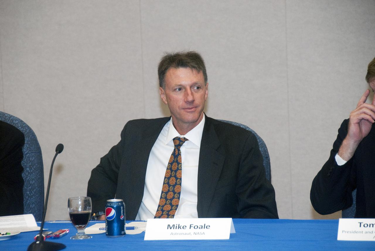CAPE CANAVERAL, Fla.  - In the mission briefing room of the Operations and Checkout Building at NASA's Kennedy Space Center in Florida, NASA Astronaut Mike Foale is a panel member of the second break-out session, 'Increasing Access To and Utilization of the International Space Station,' that is part of the Conference on the American Space Program for the 21st Century. Panel members also include Tom Pickens, President and Chief Executive Officer of Astrotech Space Operations (partially out of frame); Bretton Alexander, President of the Commercial Spaceflight Federation and Miles O'Brien, a member of the NASA Advisory Council and panel moderator. Photo Credit: NASA_Jim Grossmann