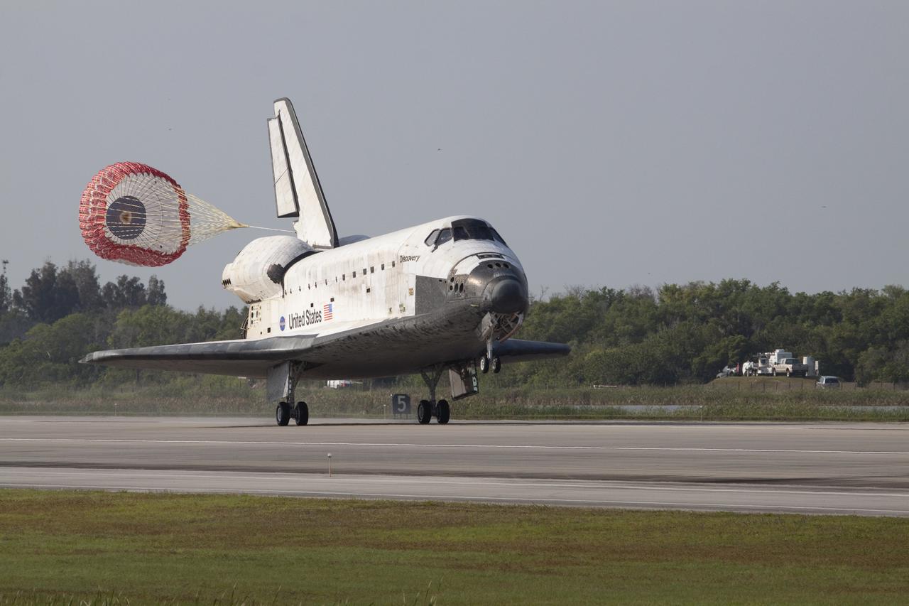 CAPE CANAVERAL, Fla.  - With drag chute unfurled, space shuttle Discovery lands on Runway 33 at the Shuttle Landing Facility at NASA's Kennedy Space Center in Florida after 15 days in space, completing the more than 6.2-million-mile STS-131 mission on orbit 238. Main gear touchdown was at 9:08:35 a.m. EDT followed by nose gear touchdown at 9:08:47 a.m. and wheelstop at 9:09:33 a.m.  Aboard are Commander Alan Poindexter; Pilot James P. Dutton Jr.; and Mission Specialists Rick Mastracchio, Clayton Anderson, Dorothy Metcalf-Lindenburger, Stephanie Wilson and Naoko Yamazaki of the Japan Aerospace Exploration Agency.  The seven-member STS-131 crew carried the multi-purpose logistics module Leonardo, filled with supplies, a new crew sleeping quarters and science racks that were transferred to the International Space Station's laboratories.  The crew also switched out a gyroscope on the station’s truss, installed a spare ammonia storage tank and retrieved a Japanese experiment from the station’s exterior.  STS-131 is the 33rd shuttle mission to the station and the 131st shuttle mission overall. For information on the STS-131 mission and crew, visit http:__www.nasa.gov_mission_pages_shuttle_shuttlemissions_sts131_index.html.  Photo Credit: NASA_Jack Pfaller