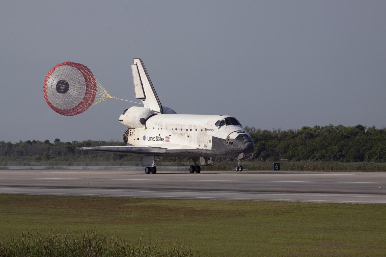 CAPE CANAVERAL, Fla.  - With drag chute unfurled, space shuttle Discovery lands on Runway 33 at the Shuttle Landing Facility at NASA's Kennedy Space Center in Florida after 15 days in space, completing the more than 6.2-million-mile STS-131 mission on orbit 238. Main gear touchdown was at 9:08:35 a.m. EDT followed by nose gear touchdown at 9:08:47 a.m. and wheelstop at 9:09:33 a.m.  Aboard are Commander Alan Poindexter; Pilot James P. Dutton Jr.; and Mission Specialists Rick Mastracchio, Clayton Anderson, Dorothy Metcalf-Lindenburger, Stephanie Wilson and Naoko Yamazaki of the Japan Aerospace Exploration Agency.  The seven-member STS-131 crew carried the multi-purpose logistics module Leonardo, filled with supplies, a new crew sleeping quarters and science racks that were transferred to the International Space Station's laboratories.  The crew also switched out a gyroscope on the station’s truss, installed a spare ammonia storage tank and retrieved a Japanese experiment from the station’s exterior.  STS-131 is the 33rd shuttle mission to the station and the 131st shuttle mission overall. For information on the STS-131 mission and crew, visit http:__www.nasa.gov_mission_pages_shuttle_shuttlemissions_sts131_index.html.  Photo Credit: NASA_Jack Pfaller