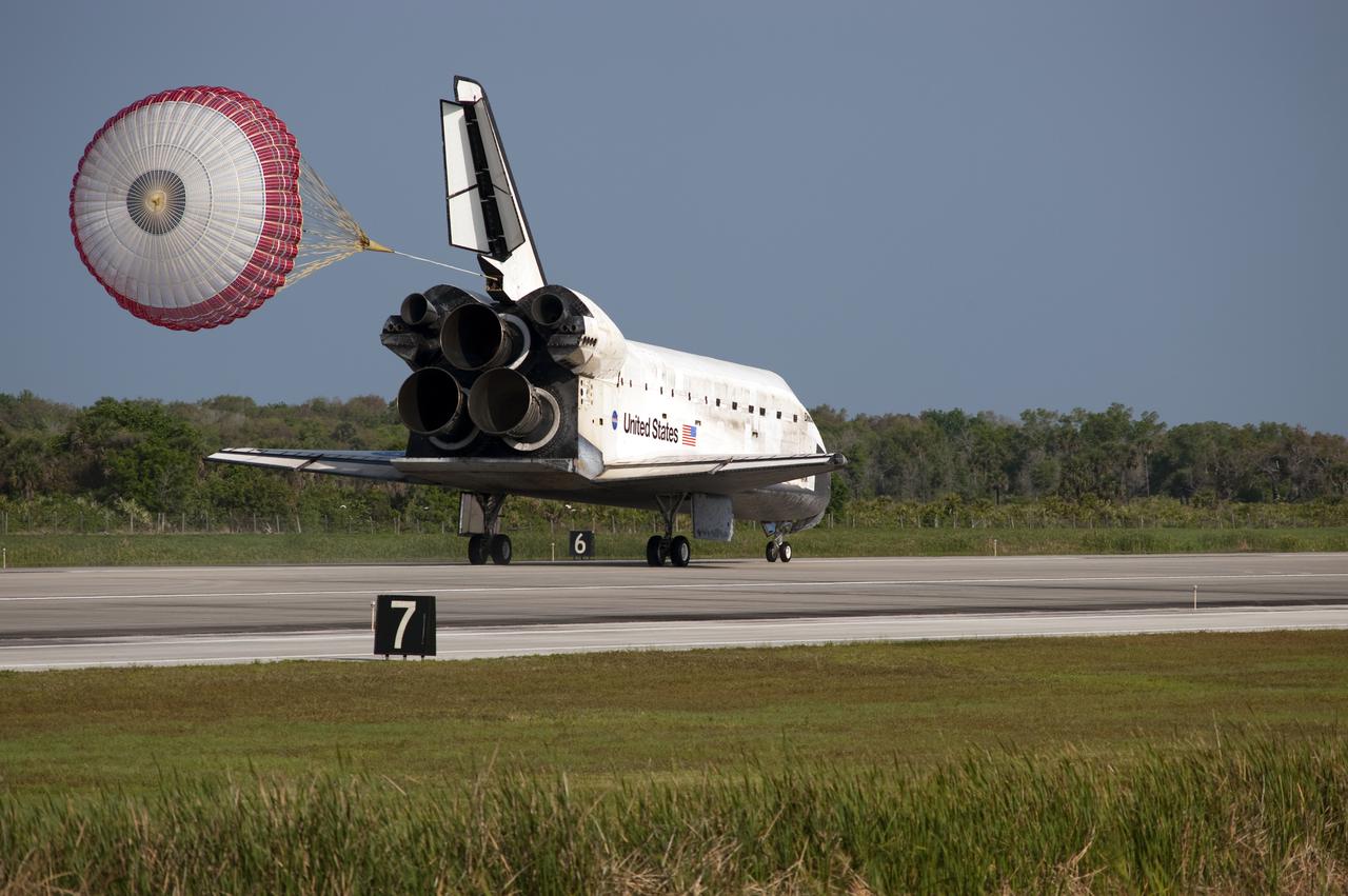 CAPE CANAVERAL, Fla.  - With drag chute unfurled, space shuttle Discovery lands on Runway 33 at the Shuttle Landing Facility at NASA's Kennedy Space Center in Florida after 15 days in space, completing the more than 6.2-million-mile STS-131 mission on orbit 238. Main gear touchdown was at 9:08:35 a.m. EDT followed by nose gear touchdown at 9:08:47 a.m. and wheelstop at 9:09:33 a.m.  Aboard are Commander Alan Poindexter; Pilot James P. Dutton Jr.; and Mission Specialists Rick Mastracchio, Clayton Anderson, Dorothy Metcalf-Lindenburger, Stephanie Wilson and Naoko Yamazaki of the Japan Aerospace Exploration Agency.  The seven-member STS-131 crew carried the multi-purpose logistics module Leonardo, filled with supplies, a new crew sleeping quarters and science racks that were transferred to the International Space Station's laboratories.  The crew also switched out a gyroscope on the station’s truss, installed a spare ammonia storage tank and retrieved a Japanese experiment from the station’s exterior.  STS-131 is the 33rd shuttle mission to the station and the 131st shuttle mission overall. For information on the STS-131 mission and crew, visit http:__www.nasa.gov_mission_pages_shuttle_shuttlemissions_sts131_index.html.  Photo Credit: NASA_Tony Gray