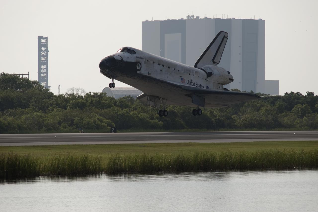 CAPE CANAVERAL, Fla.  - Space shuttle Discovery lands on Runway 33 at the Shuttle Landing Facility at NASA's Kennedy Space Center in Florida at 9:08 a.m. EDT, completing the 15-day STS-131 mission to the International Space Station. In the background is the Vehicle Assembly Building, or VAB. Main gear touchdown was at 9:08:35 a.m. EDT followed by nose gear touchdown at 9:08:47 a.m. and wheelstop at 9:09:33 a.m.  Aboard are Commander Alan Poindexter; Pilot James P. Dutton Jr.; and Mission Specialists Rick Mastracchio, Clayton Anderson, Dorothy Metcalf-Lindenburger, Stephanie Wilson and Naoko Yamazaki of the Japan Aerospace Exploration Agency.  The seven-member STS-131 crew carried the multi-purpose logistics module Leonardo, filled with supplies, a new crew sleeping quarters and science racks that were transferred to the International Space Station's laboratories.  The crew also switched out a gyroscope on the station’s truss, installed a spare ammonia storage tank and retrieved a Japanese experiment from the station’s exterior.  STS-131 is the 33rd shuttle mission to the station and the 131st shuttle mission overall. For information on the STS-131 mission and crew, visit http:__www.nasa.gov_mission_pages_shuttle_shuttlemissions_sts131_index.html.  Photo Credit: NASA_Rusty Backer