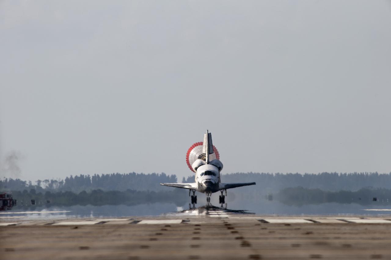 CAPE CANAVERAL, Fla. - With drag chute unfurled, space shuttle Discovery lands on Runway 33 at the Shuttle Landing Facility at NASA's Kennedy Space Center in Florida after 15 days in space, completing the more than 6.2-million-mile STS-131 mission on orbit 238.  Main gear touchdown was at 9:08:35 a.m. EDT followed by nose gear touchdown at 9:08:47 a.m. and wheelstop at 9:09:33 a.m.  Aboard are Commander Alan Poindexter; Pilot James P. Dutton Jr.; and Mission Specialists Rick Mastracchio, Clayton Anderson, Dorothy Metcalf-Lindenburger, Stephanie Wilson and Naoko Yamazaki of the Japan Aerospace Exploration Agency.  The seven-member STS-131 crew carried the multi-purpose logistics module Leonardo, filled with supplies, a new crew sleeping quarters and science racks that were transferred to the International Space Station's laboratories.  The crew also switched out a gyroscope on the station’s truss, installed a spare ammonia storage tank and retrieved a Japanese experiment from the station’s exterior.  STS-131 is the 33rd shuttle mission to the station and the 131st shuttle mission overall. For information on the STS-131 mission and crew, visit http:__www.nasa.gov_mission_pages_shuttle_shuttlemissions_sts131_index.html.  Photo credit: NASA_Sandra Joseph and Kevin O'Connell