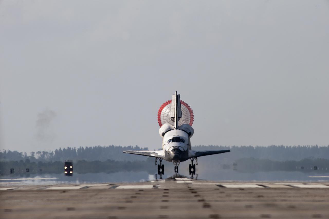 CAPE CANAVERAL, Fla. - With drag chute unfurled, space shuttle Discovery touches down on Runway 33 at the Shuttle Landing Facility at NASA's Kennedy Space Center in Florida after 15 days in space, completing the more than 6.2-million-mile STS-131 mission on orbit 238.  Main gear touchdown was at 9:08:35 a.m. EDT followed by nose gear touchdown at 9:08:47 a.m. and wheelstop at 9:09:33 a.m.  Aboard are Commander Alan Poindexter; Pilot James P. Dutton Jr.; and Mission Specialists Rick Mastracchio, Clayton Anderson, Dorothy Metcalf-Lindenburger, Stephanie Wilson and Naoko Yamazaki of the Japan Aerospace Exploration Agency.  The seven-member STS-131 crew carried the multi-purpose logistics module Leonardo, filled with supplies, a new crew sleeping quarters and science racks that were transferred to the International Space Station's laboratories.  The crew also switched out a gyroscope on the station’s truss, installed a spare ammonia storage tank and retrieved a Japanese experiment from the station’s exterior.  STS-131 is the 33rd shuttle mission to the station and the 131st shuttle mission overall. For information on the STS-131 mission and crew, visit http:__www.nasa.gov_mission_pages_shuttle_shuttlemissions_sts131_index.html.  Photo credit: NASA_Sandra Joseph and Kevin O'Connell