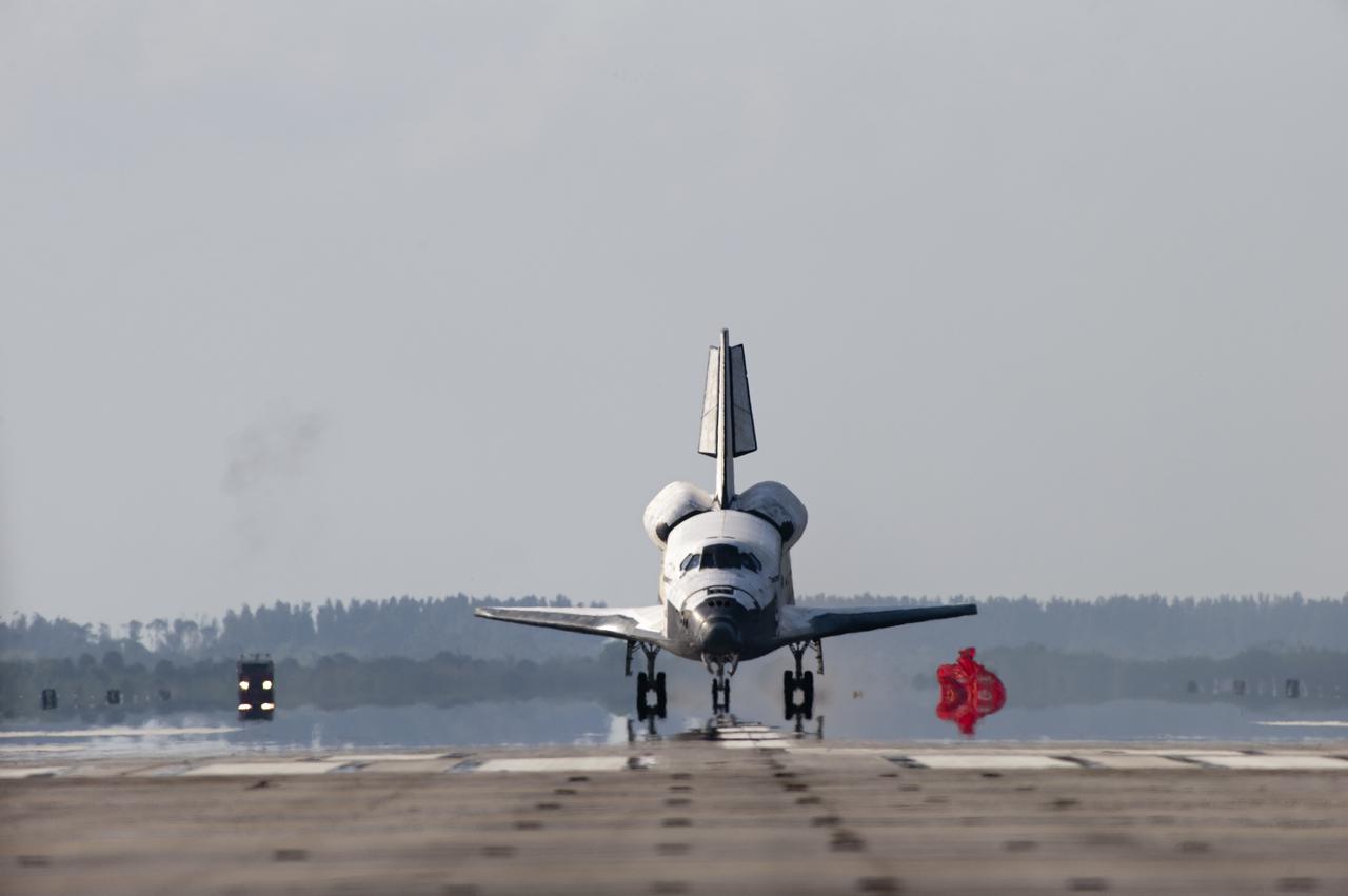CAPE CANAVERAL, Fla. - Space shuttle Discovery's drag chute is jettisoned after slowing the shuttle for its touch down on Runway 33 at the Shuttle Landing Facility at NASA's Kennedy Space Center in Florida after 15 days in space, completing the more than 6.2-million-mile STS-131 mission on orbit 238.  Main gear touchdown was at 9:08:35 a.m. EDT followed by nose gear touchdown at 9:08:47 a.m. and wheelstop at 9:09:33 a.m.  Aboard are Commander Alan Poindexter; Pilot James P. Dutton Jr.; and Mission Specialists Rick Mastracchio, Clayton Anderson, Dorothy Metcalf-Lindenburger, Stephanie Wilson and Naoko Yamazaki of the Japan Aerospace Exploration Agency.  The seven-member STS-131 crew carried the multi-purpose logistics module Leonardo, filled with supplies, a new crew sleeping quarters and science racks that were transferred to the International Space Station's laboratories.  The crew also switched out a gyroscope on the station’s truss, installed a spare ammonia storage tank and retrieved a Japanese experiment from the station’s exterior.  STS-131 is the 33rd shuttle mission to the station and the 131st shuttle mission overall. For information on the STS-131 mission and crew, visit http:__www.nasa.gov_mission_pages_shuttle_shuttlemissions_sts131_index.html.  Photo credit: NASA_Sandra Joseph and Kevin O'Connell