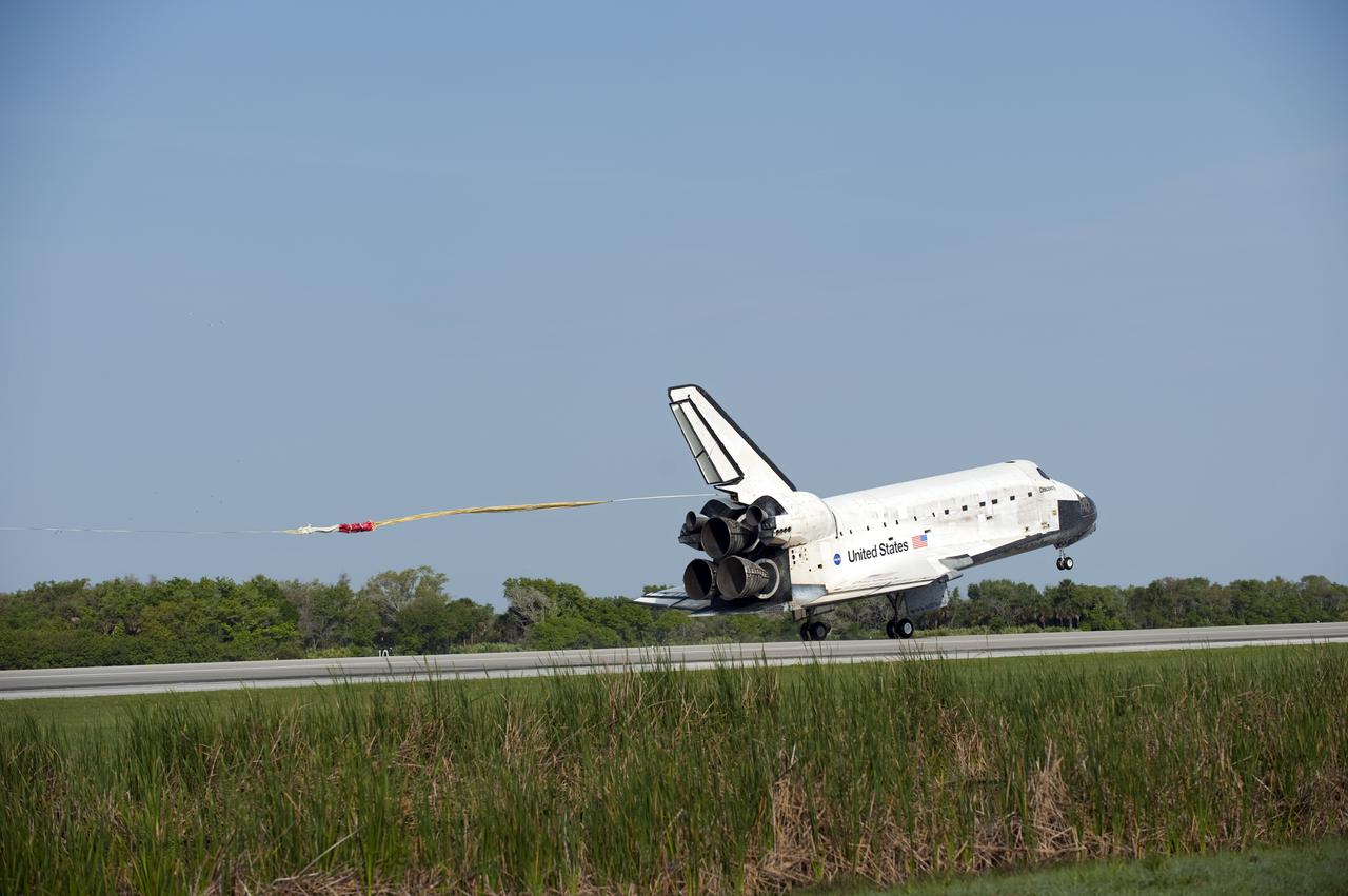 CAPE CANAVERAL, Fla. - Space shuttle Discovery's 40-foot-diameter drag chute extends with the aid of a mortar-deployed pilot chute.  Its purpose is to slow the shuttle as it lands on Runway 33 at the Shuttle Landing Facility at NASA's Kennedy Space Center in Florida after 15 days in space, completing the more than 6.2-million-mile STS-131 mission on orbit 238.  Main gear touchdown was at 9:08:35 a.m. EDT followed by nose gear touchdown at 9:08:47 a.m. and wheelstop at 9:09:33 a.m.  Aboard are Commander Alan Poindexter; Pilot James P. Dutton Jr.; and Mission Specialists Rick Mastracchio, Clayton Anderson, Dorothy Metcalf-Lindenburger, Stephanie Wilson and Naoko Yamazaki of the Japan Aerospace Exploration Agency.  The seven-member STS-131 crew carried the multi-purpose logistics module Leonardo, filled with supplies, a new crew sleeping quarters and science racks that were transferred to the International Space Station's laboratories.  The crew also switched out a gyroscope on the station’s truss, installed a spare ammonia storage tank and retrieved a Japanese experiment from the station’s exterior.  STS-131 is the 33rd shuttle mission to the station and the 131st shuttle mission overall. For information on the STS-131 mission and crew, visit http:__www.nasa.gov_mission_pages_shuttle_shuttlemissions_sts131_index.html.  Photo credit: NASA_Kevin O'Connell