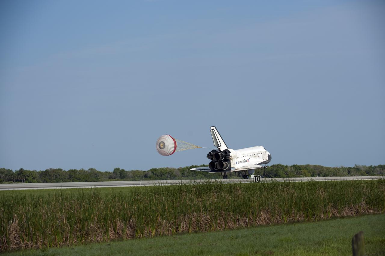 CAPE CANAVERAL, Fla. - Space shuttle Discovery's 40-foot-diameter drag chute unfurls to slow the shuttle as it lands on Runway 33 at the Shuttle Landing Facility at NASA's Kennedy Space Center in Florida after 15 days in space, completing the more than 6.2-million-mile STS-131 mission on orbit 238.  Main gear touchdown was at 9:08:35 a.m. EDT followed by nose gear touchdown at 9:08:47 a.m. and wheelstop at 9:09:33 a.m.  Aboard are Commander Alan Poindexter; Pilot James P. Dutton Jr.; and Mission Specialists Rick Mastracchio, Clayton Anderson, Dorothy Metcalf-Lindenburger, Stephanie Wilson and Naoko Yamazaki of the Japan Aerospace Exploration Agency.  The seven-member STS-131 crew carried the multi-purpose logistics module Leonardo, filled with supplies, a new crew sleeping quarters and science racks that were transferred to the International Space Station's laboratories.  The crew also switched out a gyroscope on the station’s truss, installed a spare ammonia storage tank and retrieved a Japanese experiment from the station’s exterior.  STS-131 is the 33rd shuttle mission to the station and the 131st shuttle mission overall. For information on the STS-131 mission and crew, visit http:__www.nasa.gov_mission_pages_shuttle_shuttlemissions_sts131_index.html.  Photo credit: NASA_Kevin O'Connell