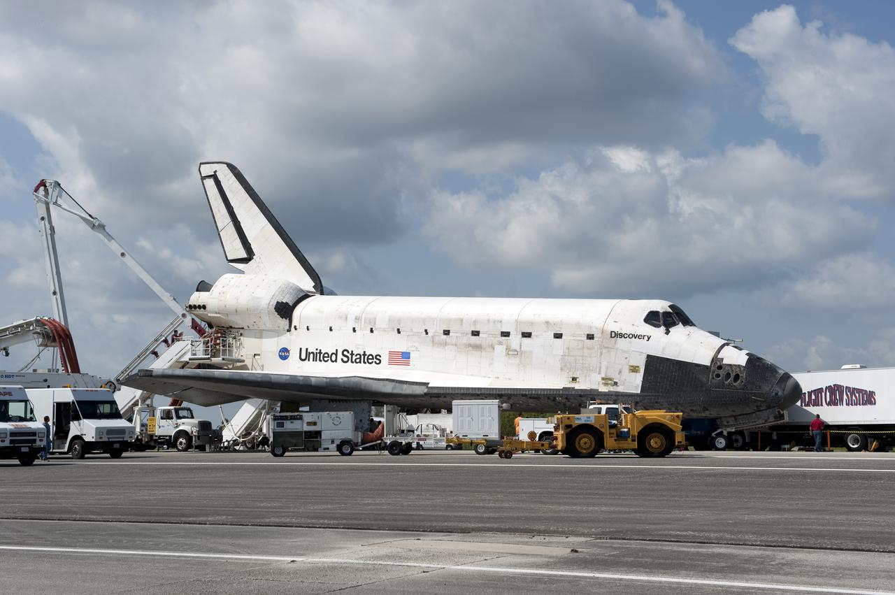 CAPE CANAVERAL, Fla. - At NASA's Kennedy Space Center in Florida, the shuttle convoy vehicles move into place around space shuttle Discovery after its landing on Runway 33 at the Shuttle Landing Facility.  Discovery landed at Kennedy after 15 days in space, completing the more than 6.2-million-mile STS-131 mission on orbit 238.  The convoy is made up of about 25 specially designed vehicles and a team of trained personnel who 'safe' the shuttle, prepare it for towing, assist the crew in leaving the shuttle, and finally, tow the shuttle to its hangar.  Main gear touchdown was at 9:08:35 a.m. EDT followed by nose gear touchdown at 9:08:47 a.m. and wheelstop at 9:09:33 a.m.  Aboard are Commander Alan Poindexter; Pilot James P. Dutton Jr.; and Mission Specialists Rick Mastracchio, Clayton Anderson, Dorothy Metcalf-Lindenburger, Stephanie Wilson and Naoko Yamazaki of the Japan Aerospace Exploration Agency.  The seven-member STS-131 crew carried the multi-purpose logistics module Leonardo, filled with supplies, a new crew sleeping quarters and science racks that were transferred to the International Space Station's laboratories.  The crew also switched out a gyroscope on the station’s truss, installed a spare ammonia storage tank and retrieved a Japanese experiment from the station’s exterior.  STS-131 is the 33rd shuttle mission to the station and the 131st shuttle mission overall. For information on the STS-131 mission and crew, visit http:__www.nasa.gov_mission_pages_shuttle_shuttlemissions_sts131_index.html.  Photo credit: NASA_Kevin O'Connell