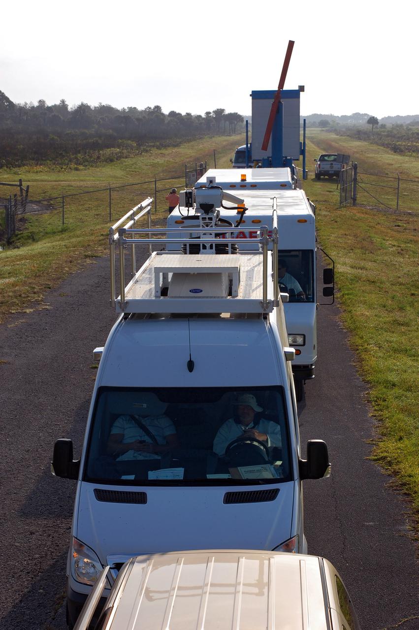 CAPE CANAVERAL, Fla. - At NASA's Kennedy Space Center in Florida, the shuttle convoy vehicles are in position near the Shuttle Landing Facility in preparation for the return of space shuttle Discovery.  The convoy is made up of about 40 vehicles, including 25 specially designed vehicles, and a team of trained personnel who 'safe' the shuttle, prepare it for towing, assist the crew in leaving the shuttle, and finally, tow the shuttle to its hangar.  Discovery landed at Kennedy after 15 days in space, completing the more than 6.2-million-mile STS-131 mission on orbit 238.  Main gear touchdown was at 9:08:35 a.m. EDT followed by nose gear touchdown at 9:08:47 a.m. and wheelstop at 9:09:33 a.m.  Aboard are Commander Alan Poindexter; Pilot James P. Dutton Jr.; and Mission Specialists Rick Mastracchio, Clayton Anderson, Dorothy Metcalf-Lindenburger, Stephanie Wilson and Naoko Yamazaki of the Japan Aerospace Exploration Agency.  The seven-member STS-131 crew carried the multi-purpose logistics module Leonardo, filled with supplies, a new crew sleeping quarters and science racks that were transferred to the International Space Station's laboratories.  The crew also switched out a gyroscope on the station’s truss, installed a spare ammonia storage tank and retrieved a Japanese experiment from the station’s exterior.  STS-131 is the 33rd shuttle mission to the station and the 131st shuttle mission overall. For information on the STS-131 mission and crew, visit http:__www.nasa.gov_mission_pages_shuttle_shuttlemissions_sts131_index.html.  Photo credit: NASA_Ben Smegelsky