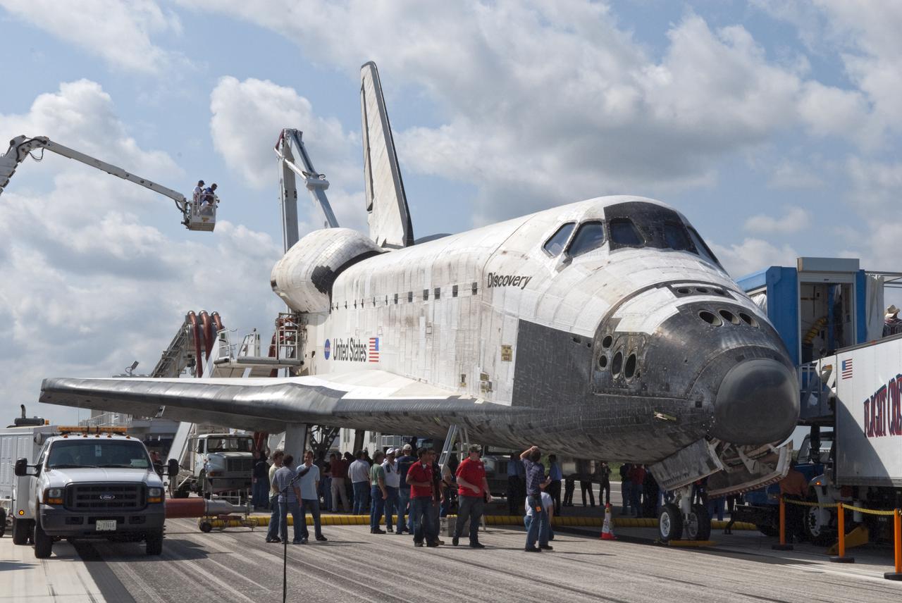CAPE CANAVERAL, Fla. - At NASA's Kennedy Space Center in Florida, members of the convoy team 'safe' space shuttle Discovery after its landing on Runway 33 at the Shuttle Landing Facility.  The convoy is made up of about 40 vehicles, including 25 specially designed vehicles, and a team of trained personnel who 'safe' the shuttle, prepare it for towing, assist the crew in leaving the shuttle, and finally, tow the shuttle to its hangar.  Main gear touchdown was at 9:08:35 a.m. EDT followed by nose gear touchdown at 9:08:47 a.m. and wheelstop at 9:09:33 a.m.  Aboard are Commander Alan Poindexter; Pilot James P. Dutton Jr.; and Mission Specialists Rick Mastracchio, Clayton Anderson, Dorothy Metcalf-Lindenburger, Stephanie Wilson and Naoko Yamazaki of the Japan Aerospace Exploration Agency.  The seven-member STS-131 crew carried the multi-purpose logistics module Leonardo, filled with supplies, a new crew sleeping quarters and science racks that were transferred to the International Space Station's laboratories.  The crew also switched out a gyroscope on the station’s truss, installed a spare ammonia storage tank and retrieved a Japanese experiment from the station’s exterior.  STS-131 is the 33rd shuttle mission to the station and the 131st shuttle mission overall. For information on the STS-131 mission and crew, visit http:__www.nasa.gov_mission_pages_shuttle_shuttlemissions_sts131_index.html.  Photo credit: NASA_Jim Grossmann