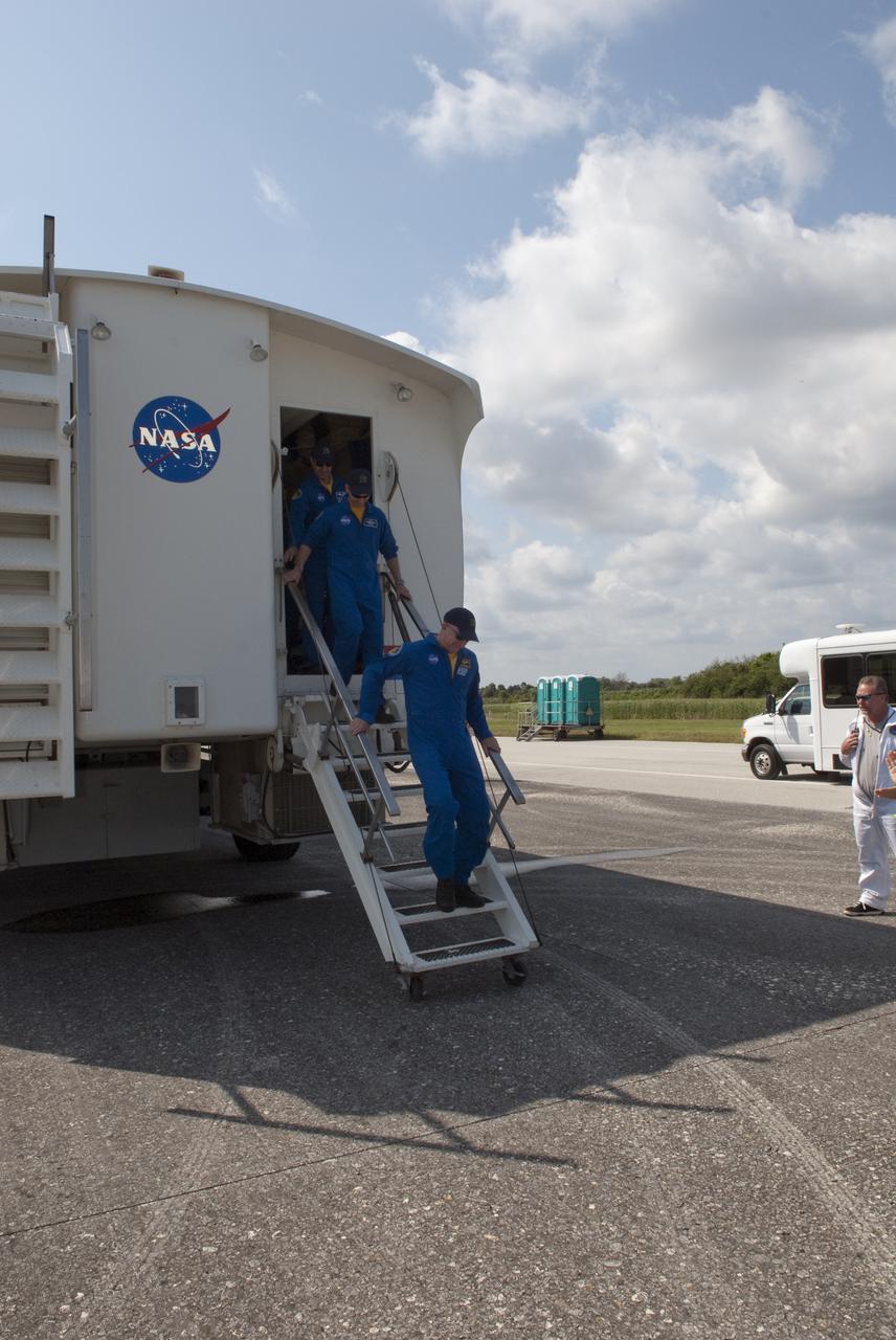 CAPE CANAVERAL, Fla. - At the Shuttle Landing Facility at NASA's Kennedy Space Center in Florida, STS-131 Commander Alan Poindexter, front, and his crew exit the crew transport vehicle following the landing of space shuttle Discovery on Runway 33.  The crew received a brief preliminary medical examination before joining NASA managers and invited guests on the runway.  Discovery landed at Kennedy after 15 days in space, completing the more than 6.2-million-mile STS-131 mission on orbit 238.  Main gear touchdown was at 9:08:35 a.m. EDT followed by nose gear touchdown at 9:08:47 a.m. and wheelstop at 9:09:33 a.m.  The seven-member STS-131 crew carried the multi-purpose logistics module Leonardo, filled with supplies, a new crew sleeping quarters and science racks that were transferred to the International Space Station's laboratories.  The crew also switched out a gyroscope on the station’s truss, installed a spare ammonia storage tank and retrieved a Japanese experiment from the station’s exterior.  STS-131 is the 33rd shuttle mission to the station and the 131st shuttle mission overall. For information on the STS-131 mission and crew, visit http:__www.nasa.gov_mission_pages_shuttle_shuttlemissions_sts131_index.html.  Photo credit: NASA_Jim Grossmann