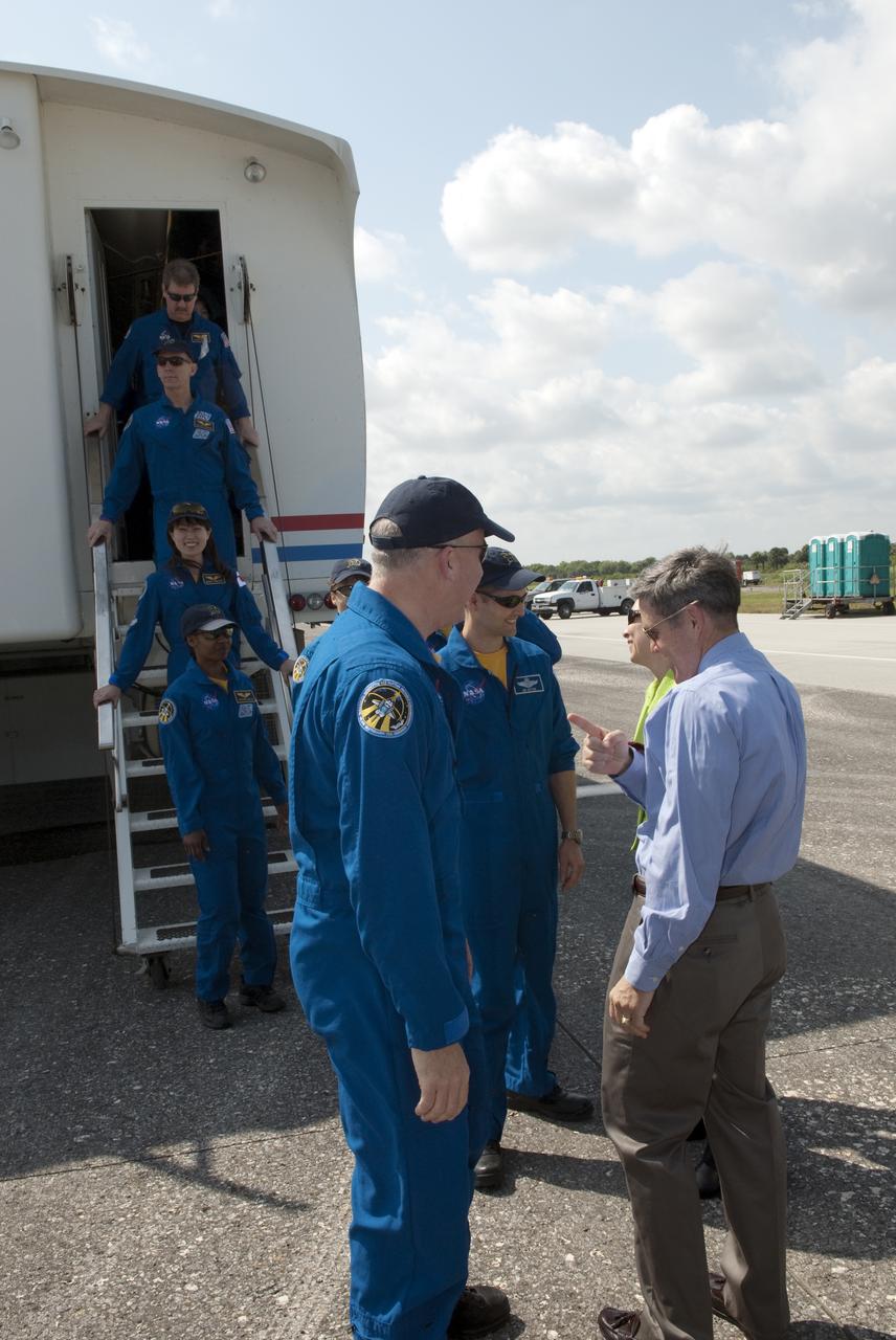 CAPE CANAVERAL, Fla. - At the Shuttle Landing Facility at NASA's Kennedy Space Center in Florida, Kennedy Director Bob Cabana, right, and NASA Deputy Administrator Lori Garver welcome the STS-131 crew back from space following the landing of space shuttle Discovery on Runway 33.  From front are Commander Alan Poindexter, Pilot James P. Dutton Jr., and Mission Specialists Rick Mastracchio and Stephanie Wilson.  Exiting the crew transport vehicle are, from bottom to top, Mission Specialists Naoko Yamazaki of the Japan Aerospace Exploration Agency, and Clayton Anderson. The crew received a brief preliminary medical examination before joining NASA managers and invited guests on the runway.  Discovery landed at Kennedy after 15 days in space, completing the more than 6.2-million-mile STS-131 mission on orbit 238.  Main gear touchdown was at 9:08:35 a.m. EDT followed by nose gear touchdown at 9:08:47 a.m. and wheelstop at 9:09:33 a.m.  The seven-member STS-131 crew carried the multi-purpose logistics module Leonardo, filled with supplies, a new crew sleeping quarters and science racks that were transferred to the International Space Station's laboratories.  The crew also switched out a gyroscope on the station’s truss, installed a spare ammonia storage tank and retrieved a Japanese experiment from the station’s exterior.  STS-131 is the 33rd shuttle mission to the station and the 131st shuttle mission overall. For information on the STS-131 mission and crew, visit http:__www.nasa.gov_mission_pages_shuttle_shuttlemissions_sts131_index.html.  Photo credit: NASA_Jim Grossmann