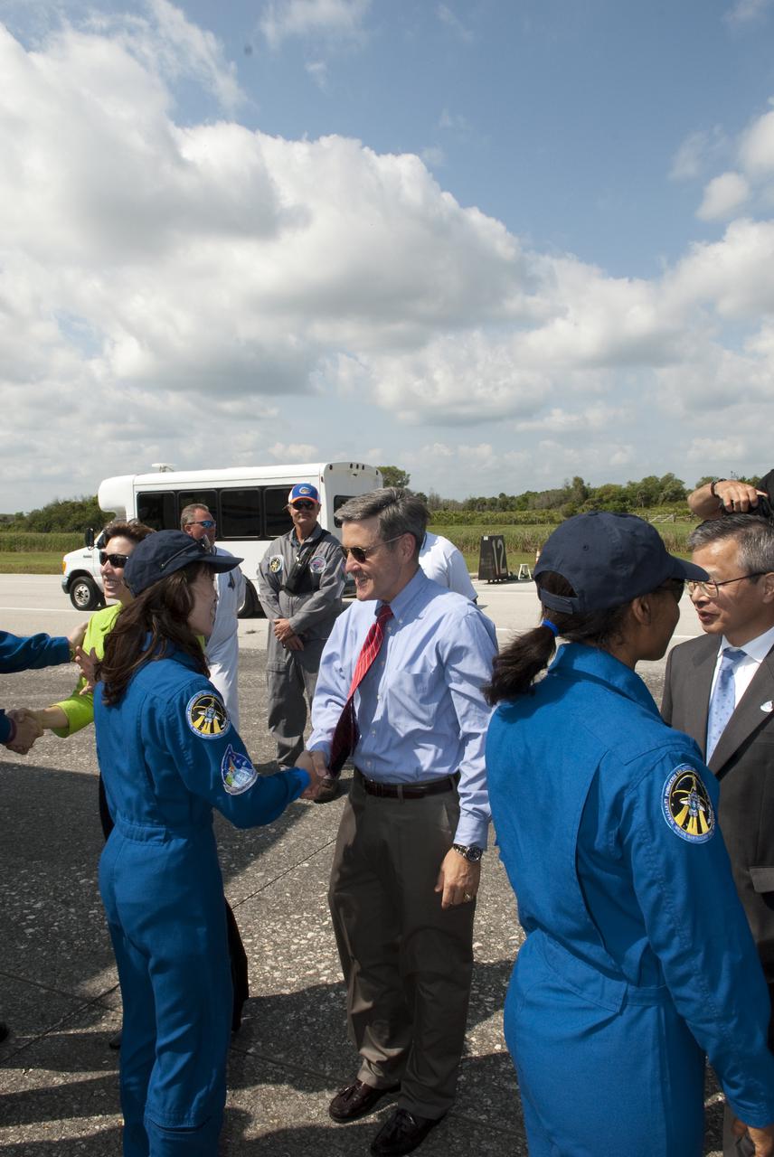 CAPE CANAVERAL, Fla. - At the Shuttle Landing Facility at NASA's Kennedy Space Center in Florida, Kennedy Director Bob Cabana congratulates STS-131 Mission Specialist Naoko Yamazaki of the Japan Aerospace Exploration Agency, at left, on a successful mission following the landing of space shuttle Discovery on Runway 33.  At right is her crewmate, Mission Specialist Stephanie Wilson.  Discovery landed at Kennedy after 15 days in space, completing the more than 6.2-million-mile STS-131 mission on orbit 238.  Main gear touchdown was at 9:08:35 a.m. EDT followed by nose gear touchdown at 9:08:47 a.m. and wheelstop at 9:09:33 a.m.  The seven-member STS-131 crew carried the multi-purpose logistics module Leonardo, filled with supplies, a new crew sleeping quarters and science racks that were transferred to the International Space Station's laboratories.  The crew also switched out a gyroscope on the station’s truss, installed a spare ammonia storage tank and retrieved a Japanese experiment from the station’s exterior.  STS-131 is the 33rd shuttle mission to the station and the 131st shuttle mission overall. For information on the STS-131 mission and crew, visit http:__www.nasa.gov_mission_pages_shuttle_shuttlemissions_sts131_index.html.  Photo credit: NASA_Jim Grossmann