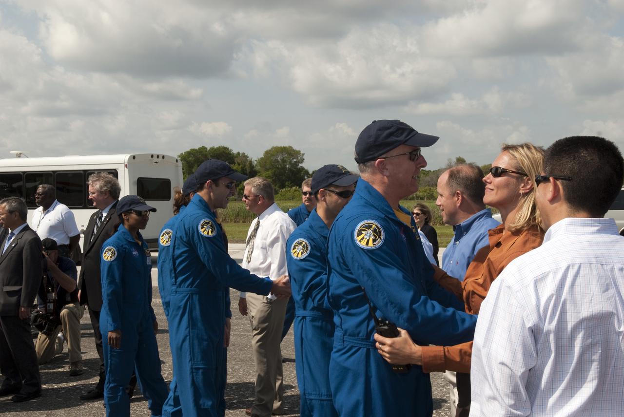 CAPE CANAVERAL, Fla. - At the Shuttle Landing Facility at NASA's Kennedy Space Center in Florida, members of the STS-131 crew are congratulated on a successful mission by NASA managers and invited guests on hand for the landing of space shuttle Discovery on Runway 33.  The astronauts are, from left, Mission Specialists Stephanie Wilson, Dorothy Metcalf-Lindenburger and Rick Mastracchio; Pilot James P. Dutton Jr.; and Commander Alan Poindexter, talking with Discovery Flow Director Stephanie Stilson.  Discovery landed at Kennedy after 15 days in space, completing the more than 6.2-million-mile STS-131 mission on orbit 238.  Main gear touchdown was at 9:08:35 a.m. EDT followed by nose gear touchdown at 9:08:47 a.m. and wheelstop at 9:09:33 a.m.  The seven-member STS-131 crew carried the multi-purpose logistics module Leonardo, filled with supplies, a new crew sleeping quarters and science racks that were transferred to the International Space Station's laboratories.  The crew also switched out a gyroscope on the station’s truss, installed a spare ammonia storage tank and retrieved a Japanese experiment from the station’s exterior.  STS-131 is the 33rd shuttle mission to the station and the 131st shuttle mission overall. For information on the STS-131 mission and crew, visit http:__www.nasa.gov_mission_pages_shuttle_shuttlemissions_sts131_index.html.  Photo credit: NASA_Jim Grossmann