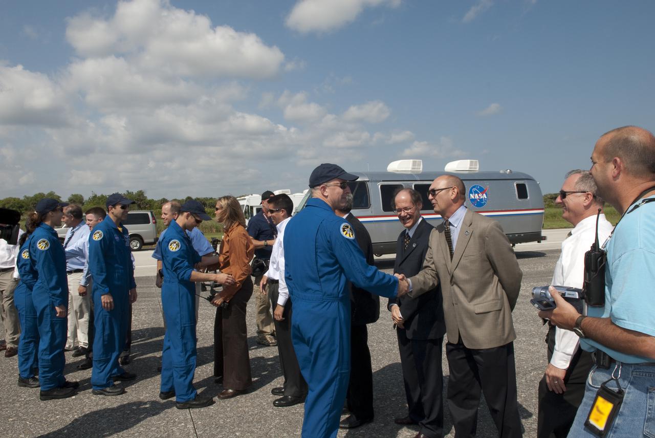 CAPE CANAVERAL, Fla. - At the Shuttle Landing Facility at NASA's Kennedy Space Center in Florida, James Cawby, director of Manufacturing and Processing, Launch and Recovery Systems, United Space Alliance, congratulates STS-131 Commander Alan Poindexter on a successful mission following the landing of space shuttle Discovery on Runway 33.  On Cawby's right in the receiving line is Mike Orr, director of Launch and Recovery Systems Engineering, United Space Alliance.  Pete Nickolenko, NASA's STS-131 launch director is on Cawby's left.  The astronauts are, from left, Mission Specialists Naoko Yamazaki of the Japan Aerospace Exploration Agency, Dorothy Metcalf-Lindenburger and Rick Mastracchio; Pilot James P. Dutton Jr.; and Poindexter.  Discovery landed at Kennedy after 15 days in space, completing the more than 6.2-million-mile STS-131 mission on orbit 238.  Main gear touchdown was at 9:08:35 a.m. EDT followed by nose gear touchdown at 9:08:47 a.m. and wheelstop at 9:09:33 a.m.  The seven-member STS-131 crew carried the multi-purpose logistics module Leonardo, filled with supplies, a new crew sleeping quarters and science racks that were transferred to the International Space Station's laboratories.  The crew also switched out a gyroscope on the station’s truss, installed a spare ammonia storage tank and retrieved a Japanese experiment from the station’s exterior.  STS-131 is the 33rd shuttle mission to the station and the 131st shuttle mission overall. For information on the STS-131 mission and crew, visit http:__www.nasa.gov_mission_pages_shuttle_shuttlemissions_sts131_index.html.  Photo credit: NASA_Jim Grossmann