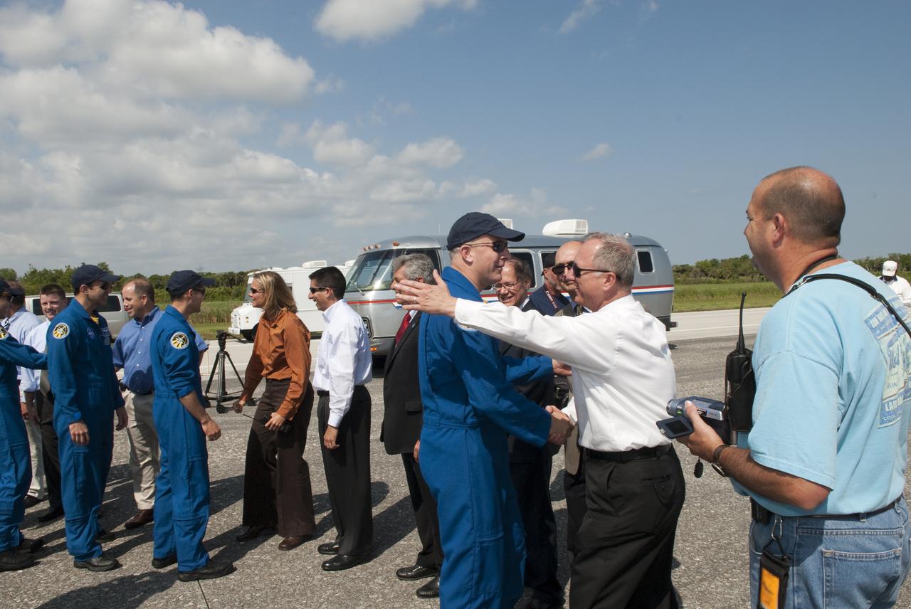 CAPE CANAVERAL, Fla. - At the Shuttle Landing Facility at NASA's Kennedy Space Center in Florida, STS-131 Launch Director Pete Nickolenko, second from right, congratulates STS-131 Commander Alan Poindexter on a successful mission following landing of space shuttle Discovery on Runway 33.  Other members of the STS-131 crew are, from left, Mission Specialist Rick Mastracchio and Pilot James P. Dutton Jr.  Discovery landed at Kennedy after 15 days in space, completing the more than 6.2-million-mile STS-131 mission on orbit 238.  Main gear touchdown was at 9:08:35 a.m. EDT followed by nose gear touchdown at 9:08:47 a.m. and wheelstop at 9:09:33 a.m.  The seven-member STS-131 crew carried the multi-purpose logistics module Leonardo, filled with supplies, a new crew sleeping quarters and science racks that were transferred to the International Space Station's laboratories.  The crew also switched out a gyroscope on the station’s truss, installed a spare ammonia storage tank and retrieved a Japanese experiment from the station’s exterior.  STS-131 is the 33rd shuttle mission to the station and the 131st shuttle mission overall. For information on the STS-131 mission and crew, visit http:__www.nasa.gov_mission_pages_shuttle_shuttlemissions_sts131_index.html.  Photo credit: NASA_Jim Grossmann