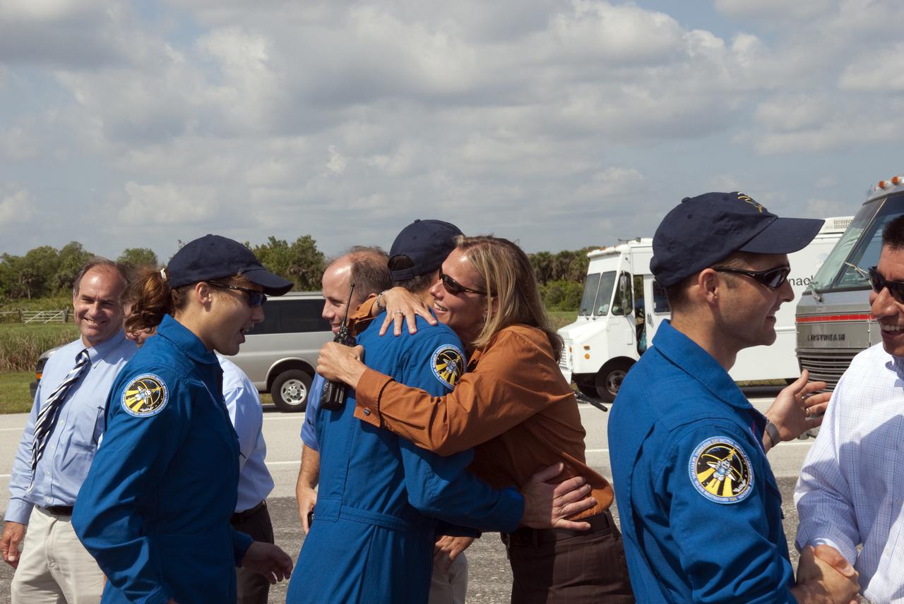 CAPE CANAVERAL, Fla. - At the Shuttle Landing Facility at NASA's Kennedy Space Center in Florida, STS-131 Mission Specialist Rick Mastracchio receives a hug from space shuttle Discovery Flow Director Stephanie Stilson, congratulating him on a successful mission as Mission Specialist Dorothy Metcalf-Lindenburger looks on.  Pilot James P. Dutton Jr. is at right.  Discovery landed at Kennedy after 15 days in space, completing the more than 6.2-million-mile STS-131 mission on orbit 238.  Main gear touchdown was at 9:08:35 a.m. EDT followed by nose gear touchdown at 9:08:47 a.m. and wheelstop at 9:09:33 a.m.  The seven-member STS-131 crew carried the multi-purpose logistics module Leonardo, filled with supplies, a new crew sleeping quarters and science racks that were transferred to the International Space Station's laboratories.  The crew also switched out a gyroscope on the station’s truss, installed a spare ammonia storage tank and retrieved a Japanese experiment from the station’s exterior.  STS-131 is the 33rd shuttle mission to the station and the 131st shuttle mission overall. For information on the STS-131 mission and crew, visit http:__www.nasa.gov_mission_pages_shuttle_shuttlemissions_sts131_index.html.  Photo credit: NASA_Jim Grossmann